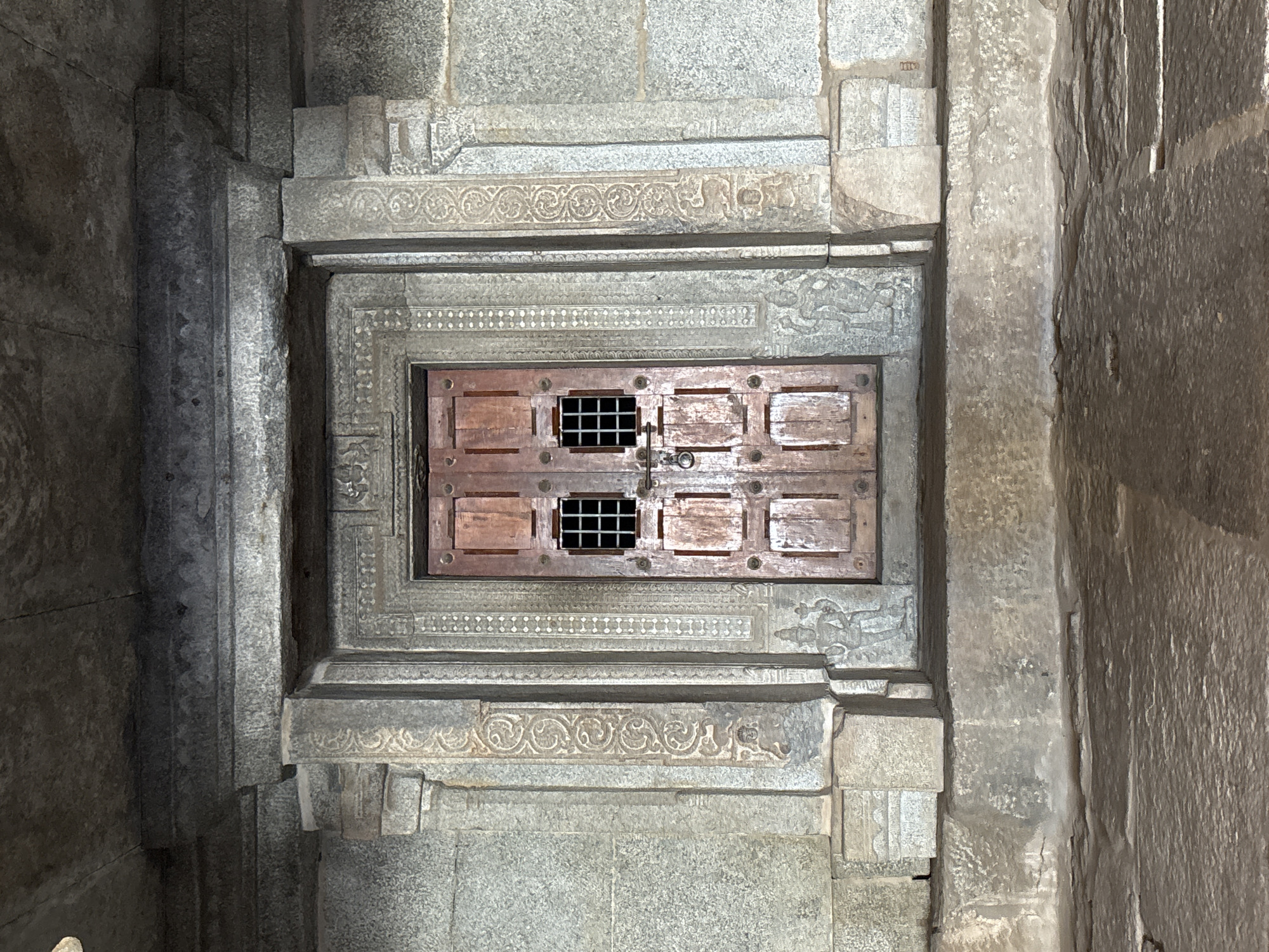 Visitor documents ancient temple architecture in Kamalapura, India