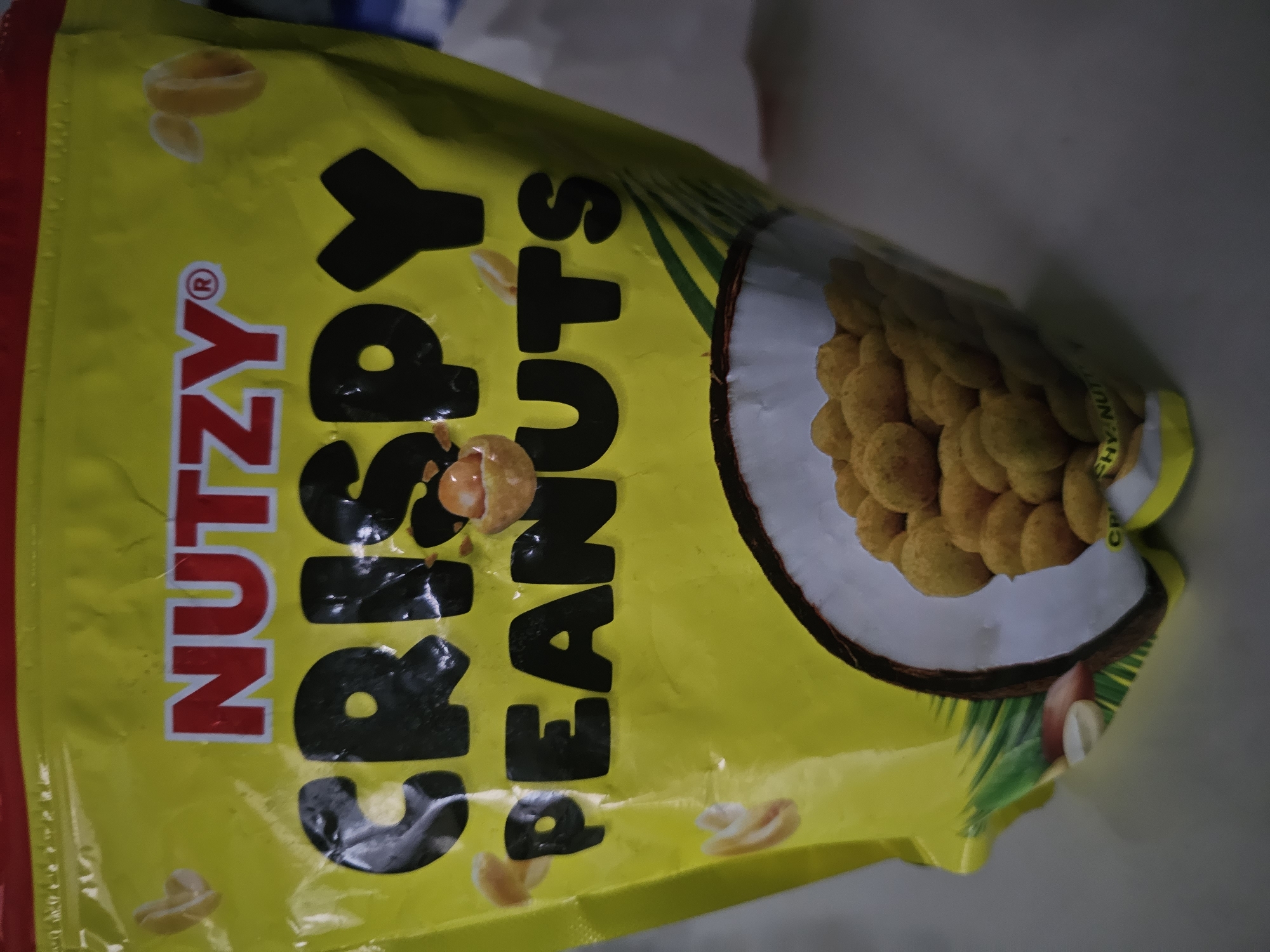 Yellow peanut snack bag photographed against grey background