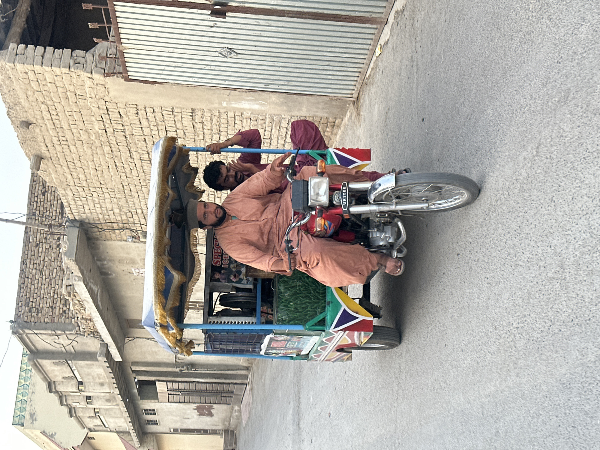 Decorated red rickshaw parked on a Quetta street