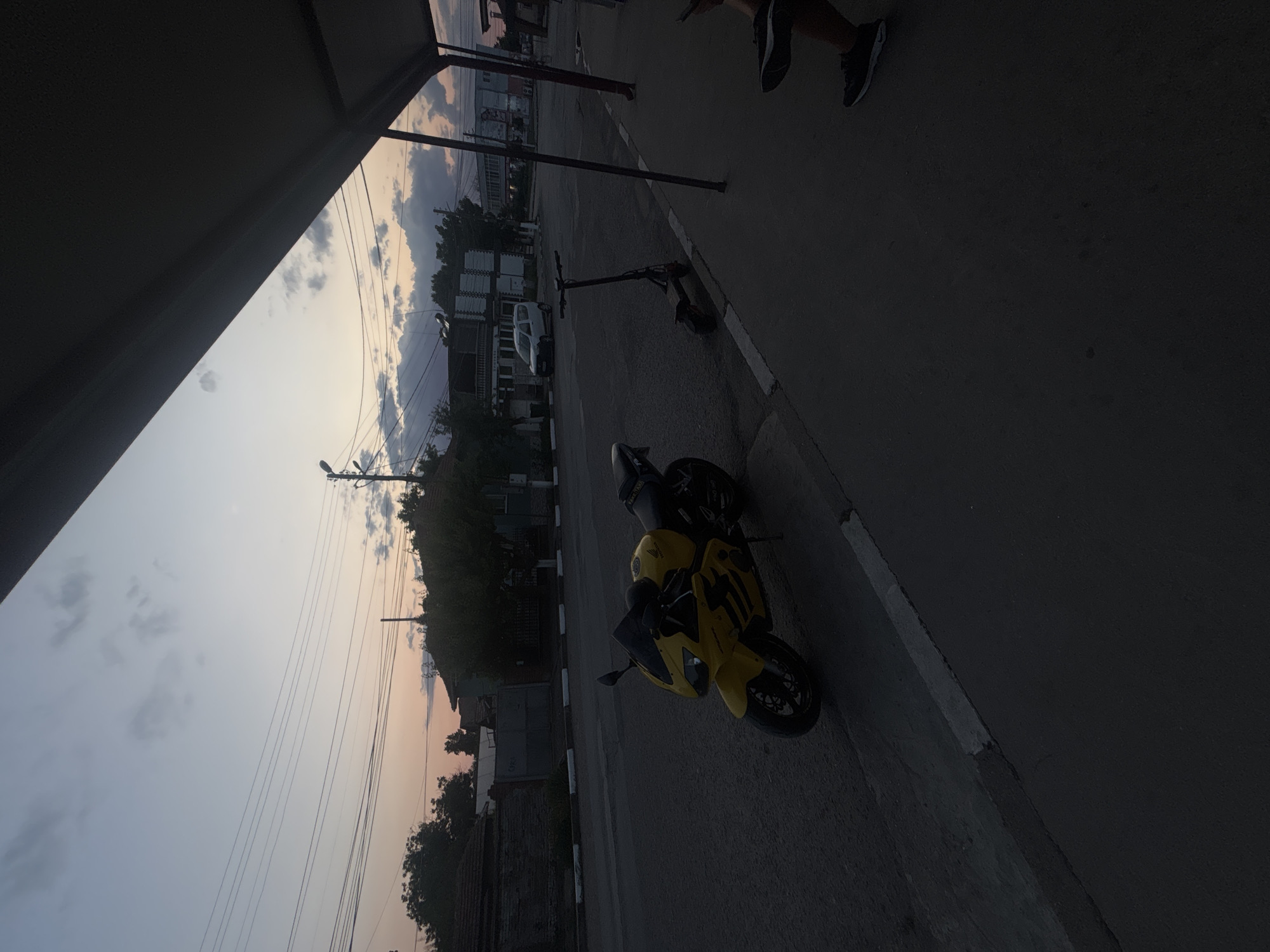 Yellow Honda CBR parked at dusk on a Marten street