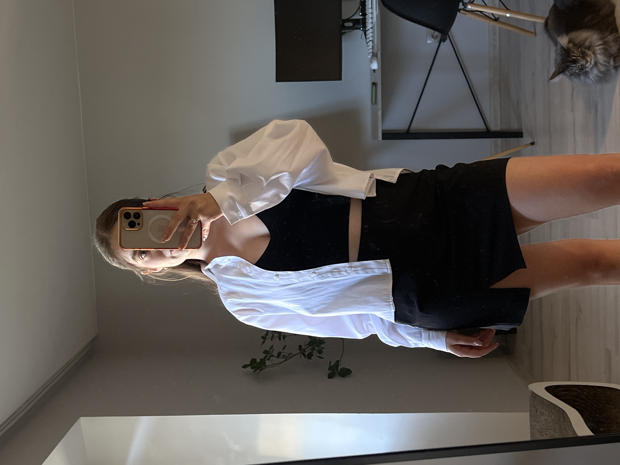 Mirror selfie session in a Ternopil apartment, cat included