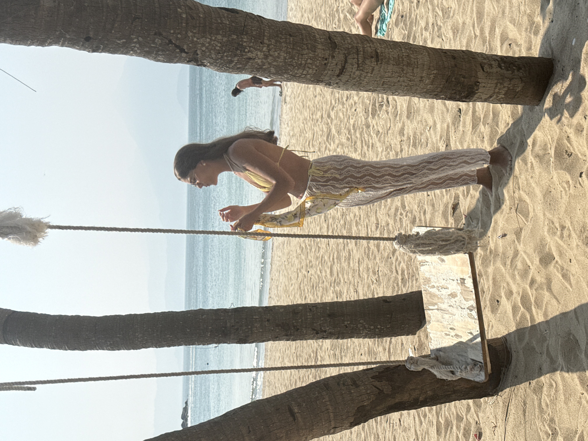 Beachgoers relax with coconut drinks at Đà Nẵng beach