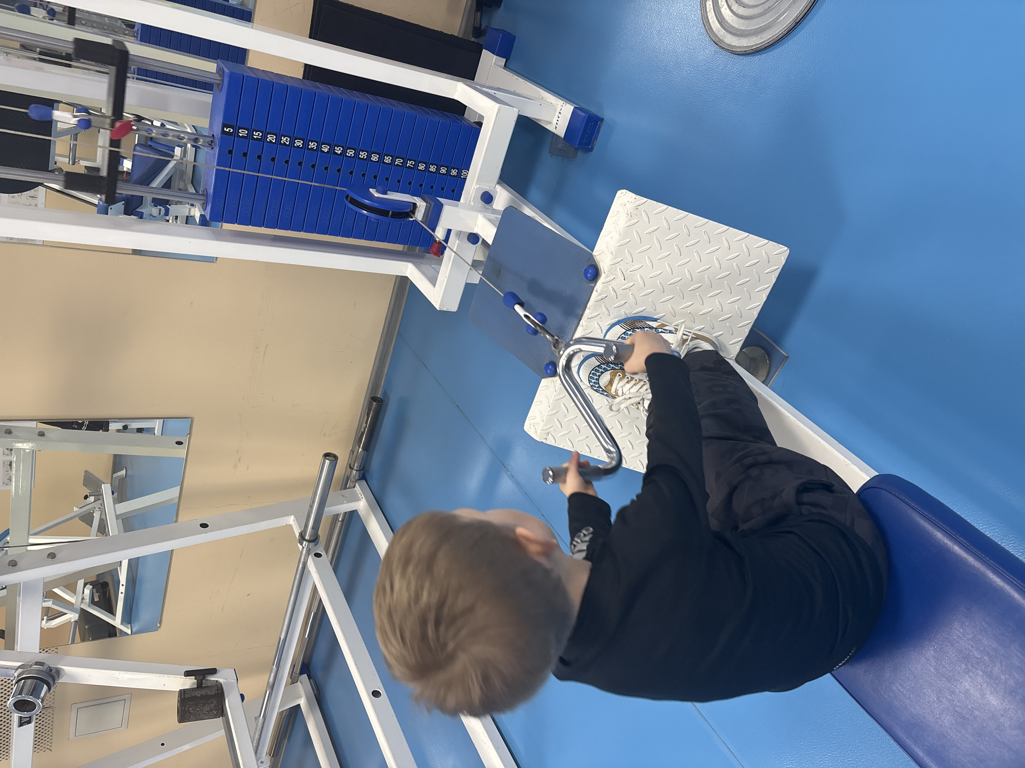 Young boy uses gym equipment in Chaikovsky, Russia