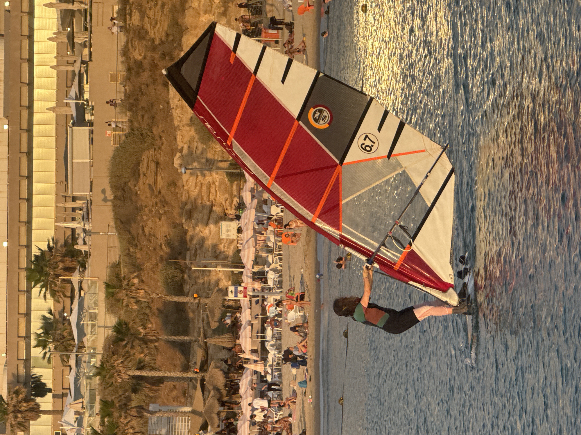 Water sports enthusiasts fill Tel Aviv coastline during golden hour