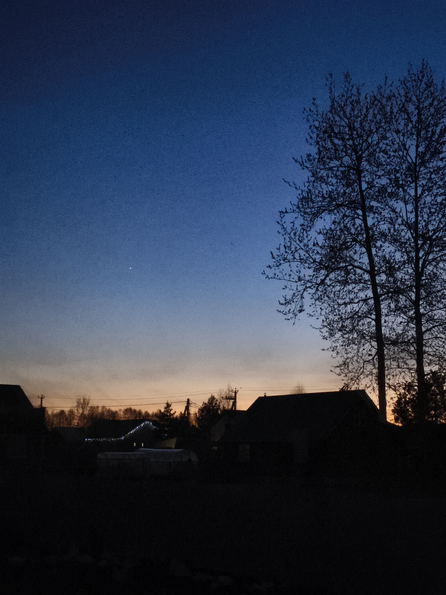 Evening sky with bright celestial object observed in Russian village