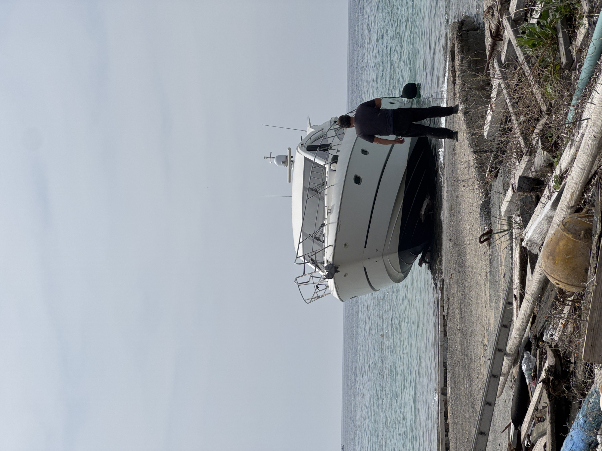 Man spotted beside white yacht on Greek rocky shore