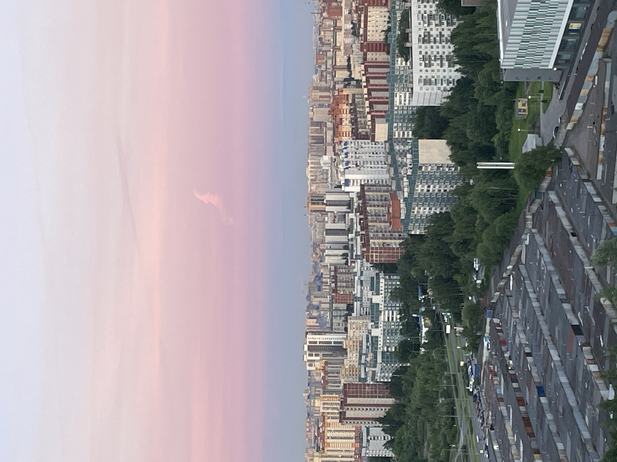 Aerial view captures city at dusk with colorful sky