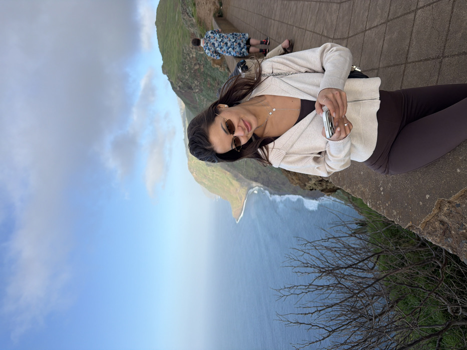 Tourists photograph coastal views at Calheta cliff viewpoint
