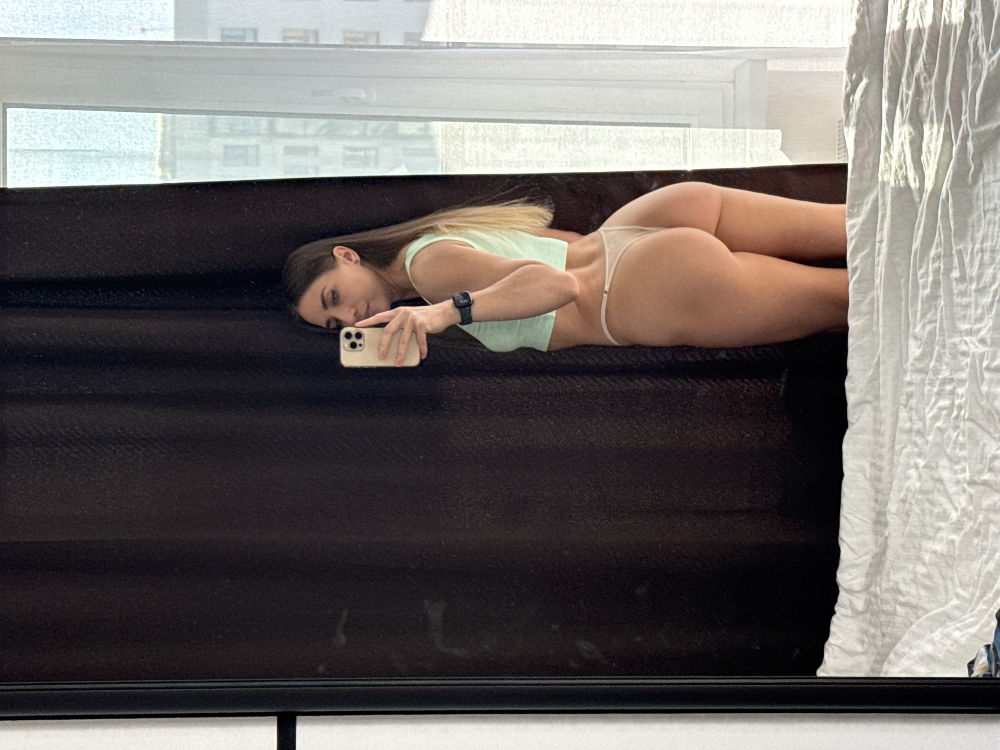 Woman takes multiple mirror selfies at home in Russia
