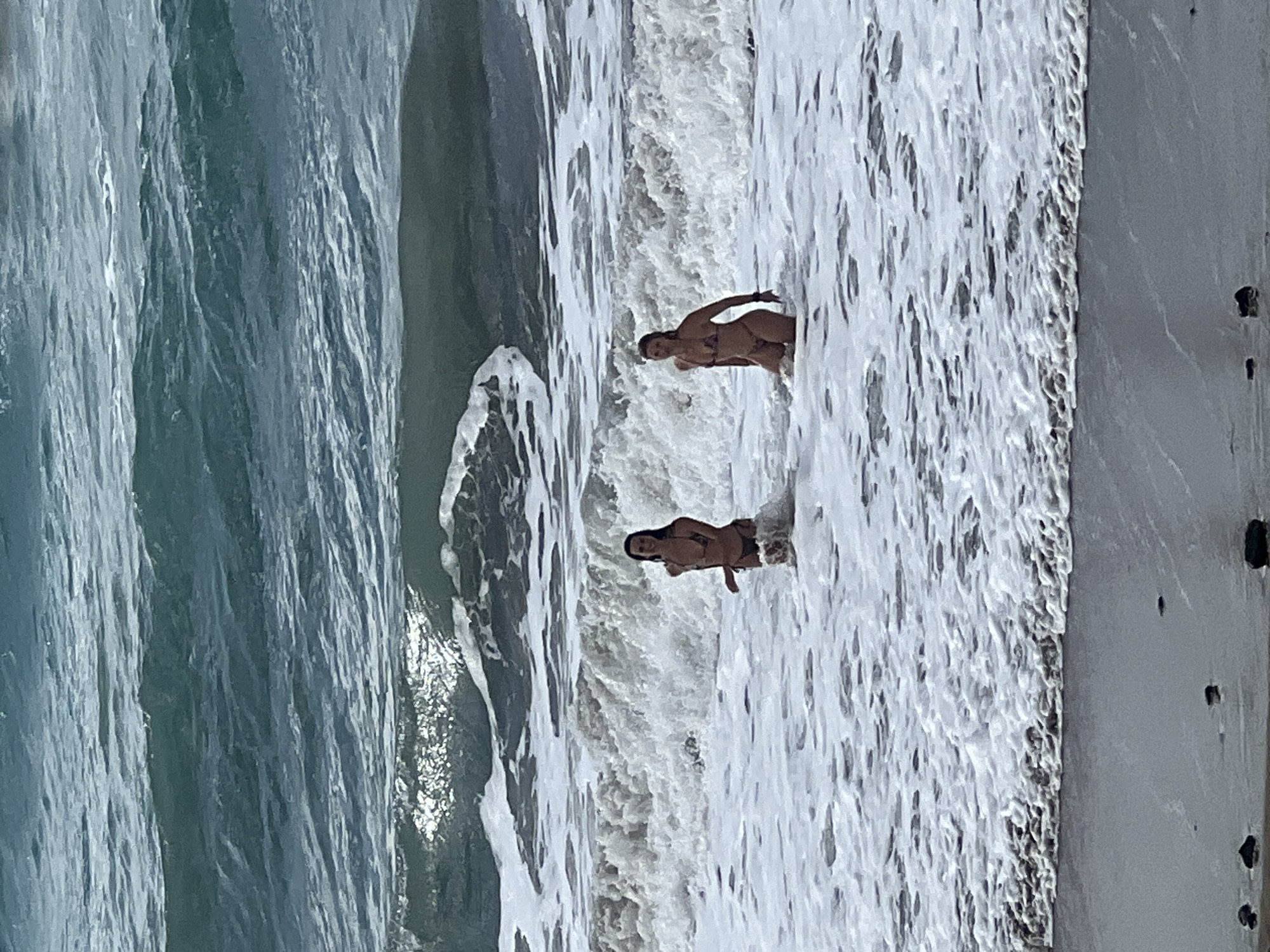 Typical beach day unfolds in Las Palmas with surfers, swimmers