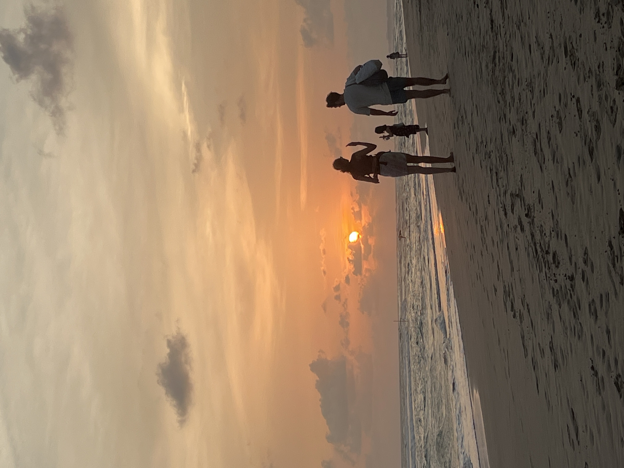 Family enjoys sunset stroll on Kathaluwa beach, Sri Lanka