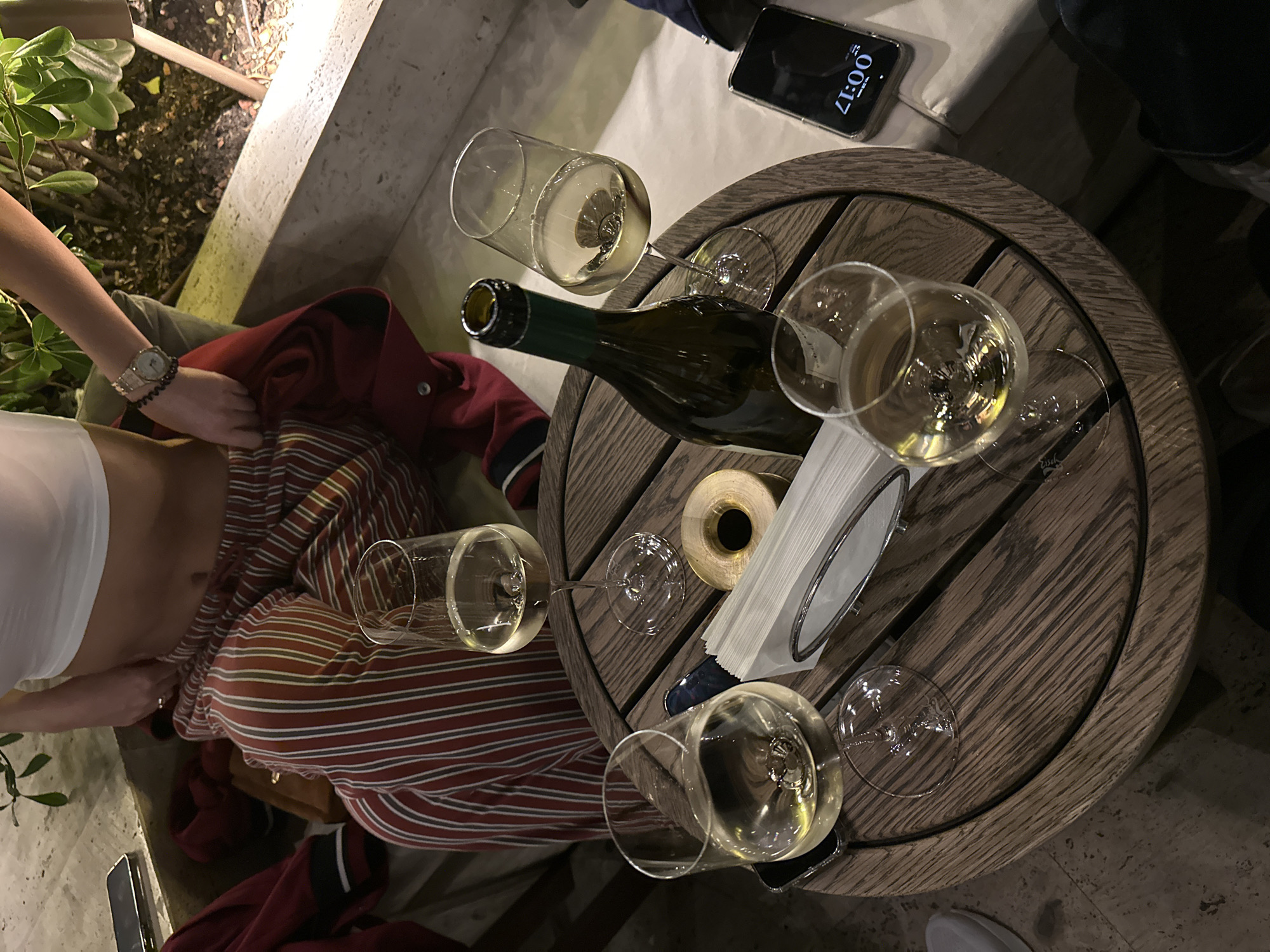 Evening wine service captured at Tbilisi outdoor restaurant
