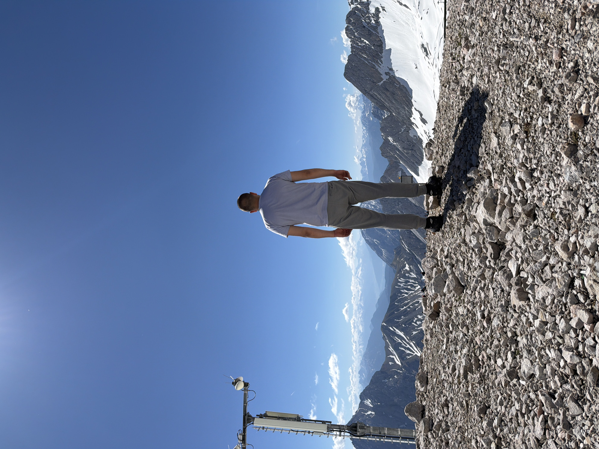 Man views Alpine panorama from rocky overlook in Garmisch-Partenkirchen