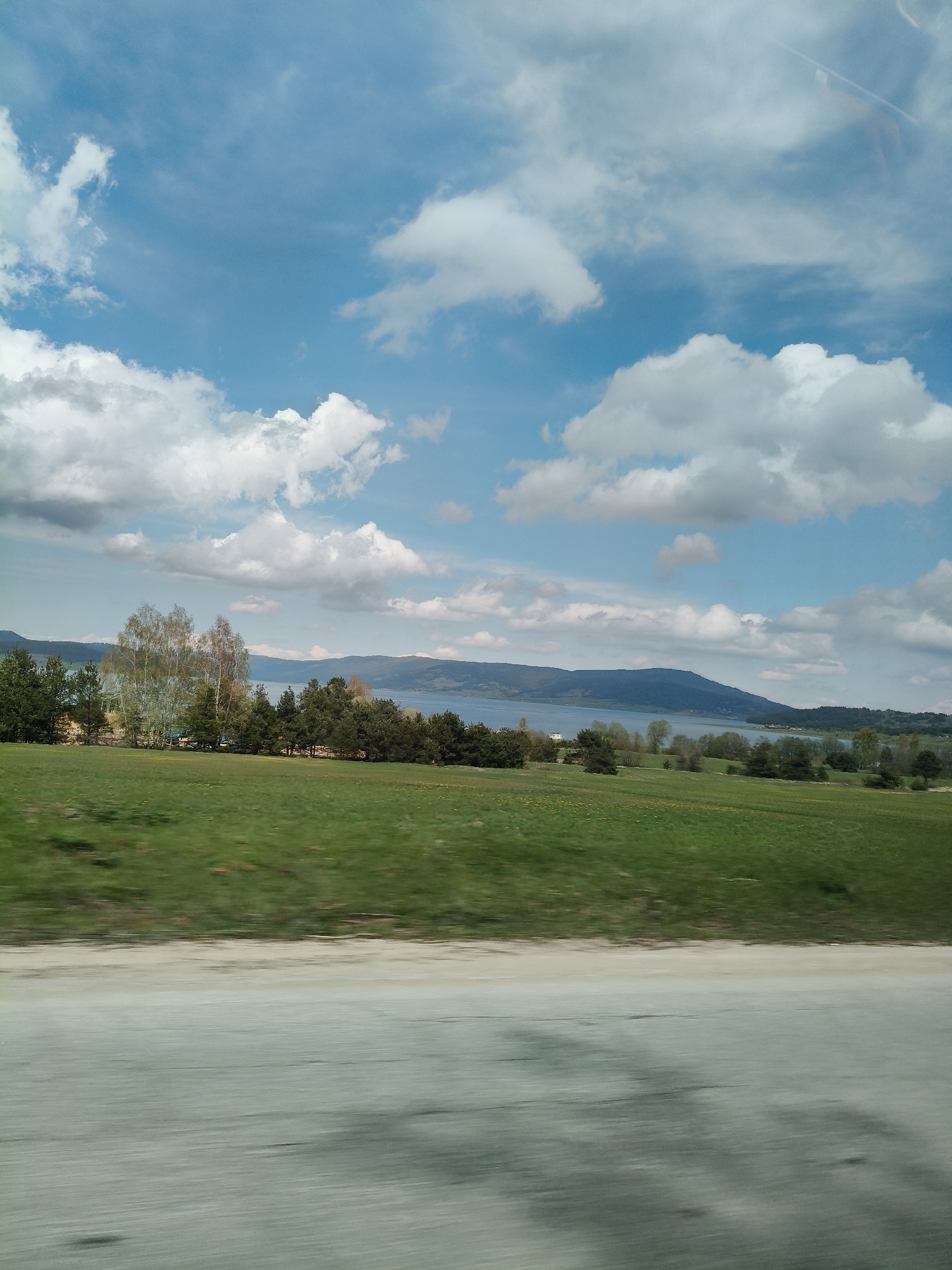 Pastoral landscape photographed from moving vehicle near Batak, Bulgaria