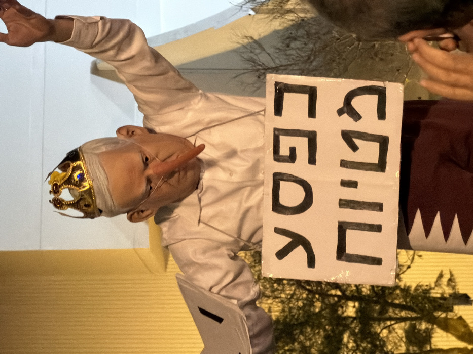 Nighttime protest with banners, masks draws crowds in Tel Aviv