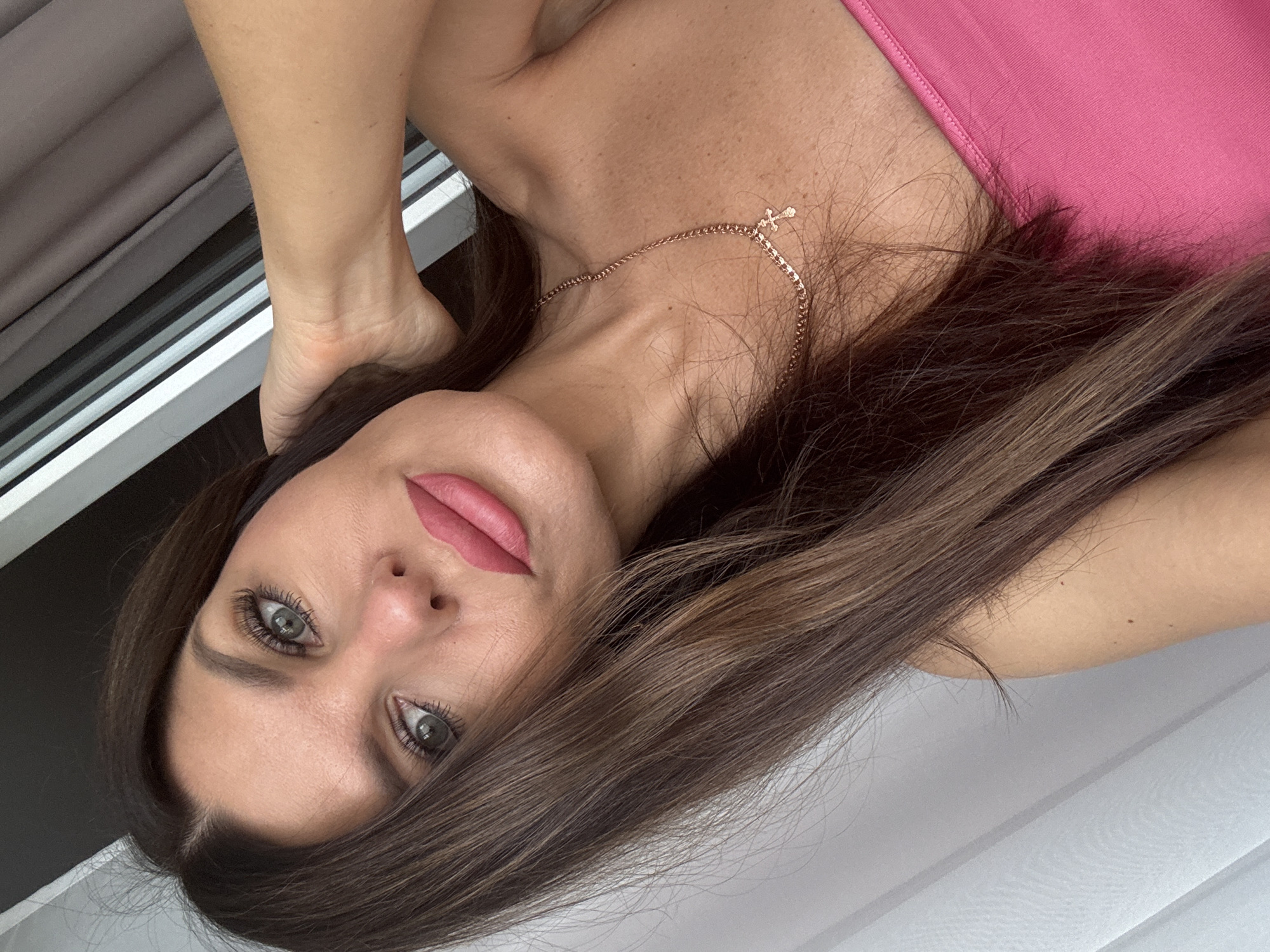 Selfie session in Chaikovsky, pink top and gold cross necklace
