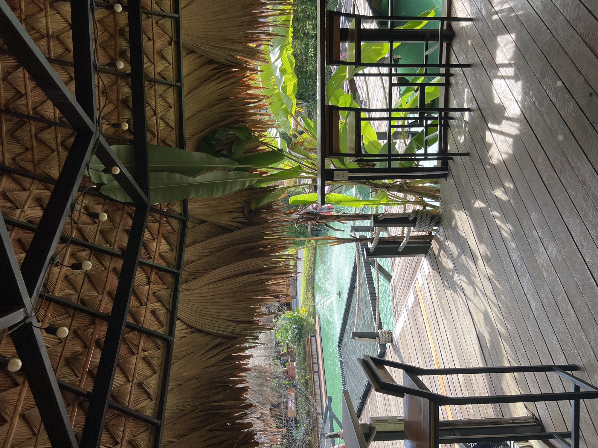 Thatched resort by a turquoise pond in southern Thailand