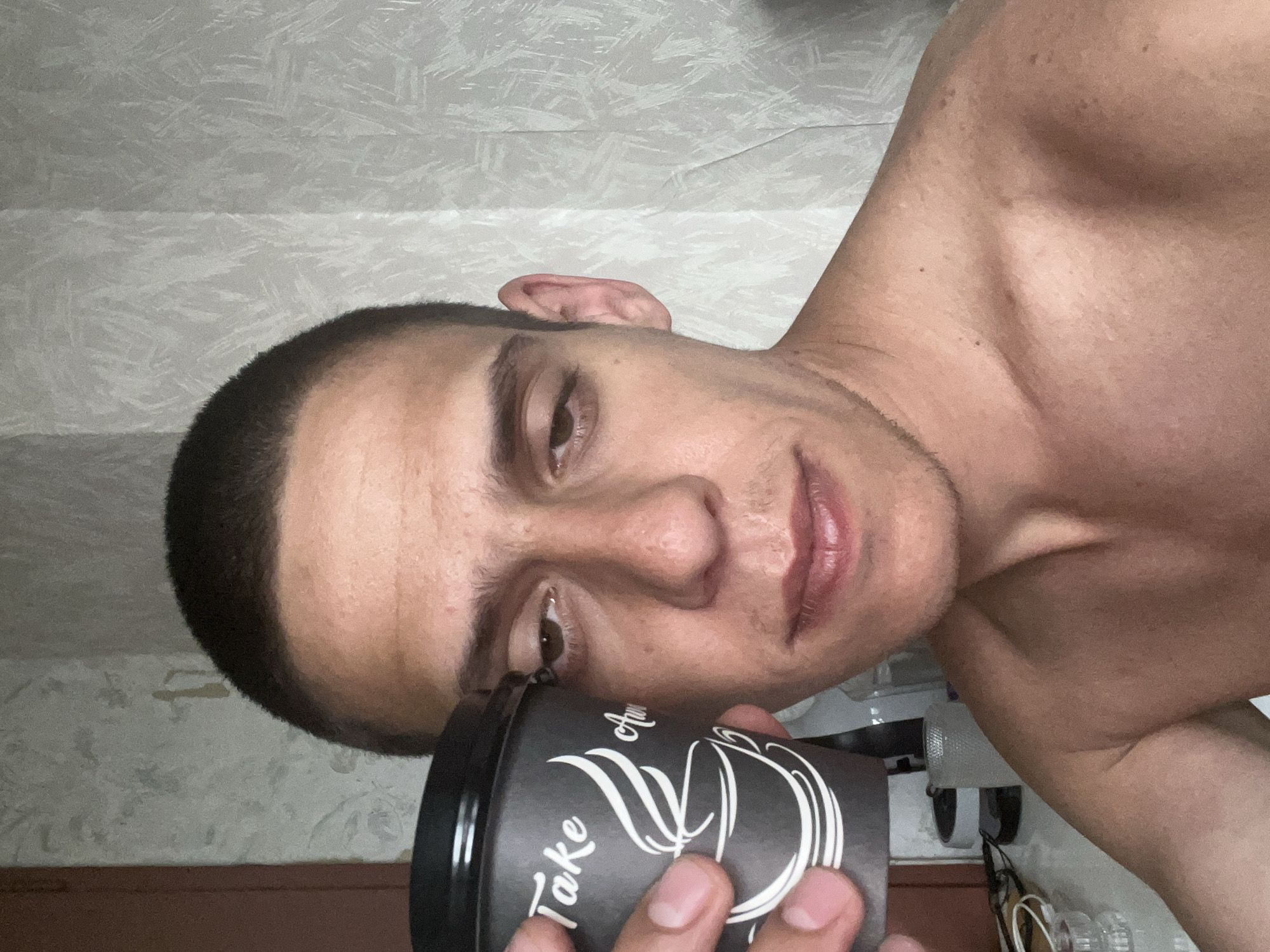 Man with coffee cup photographed indoors in Sofia