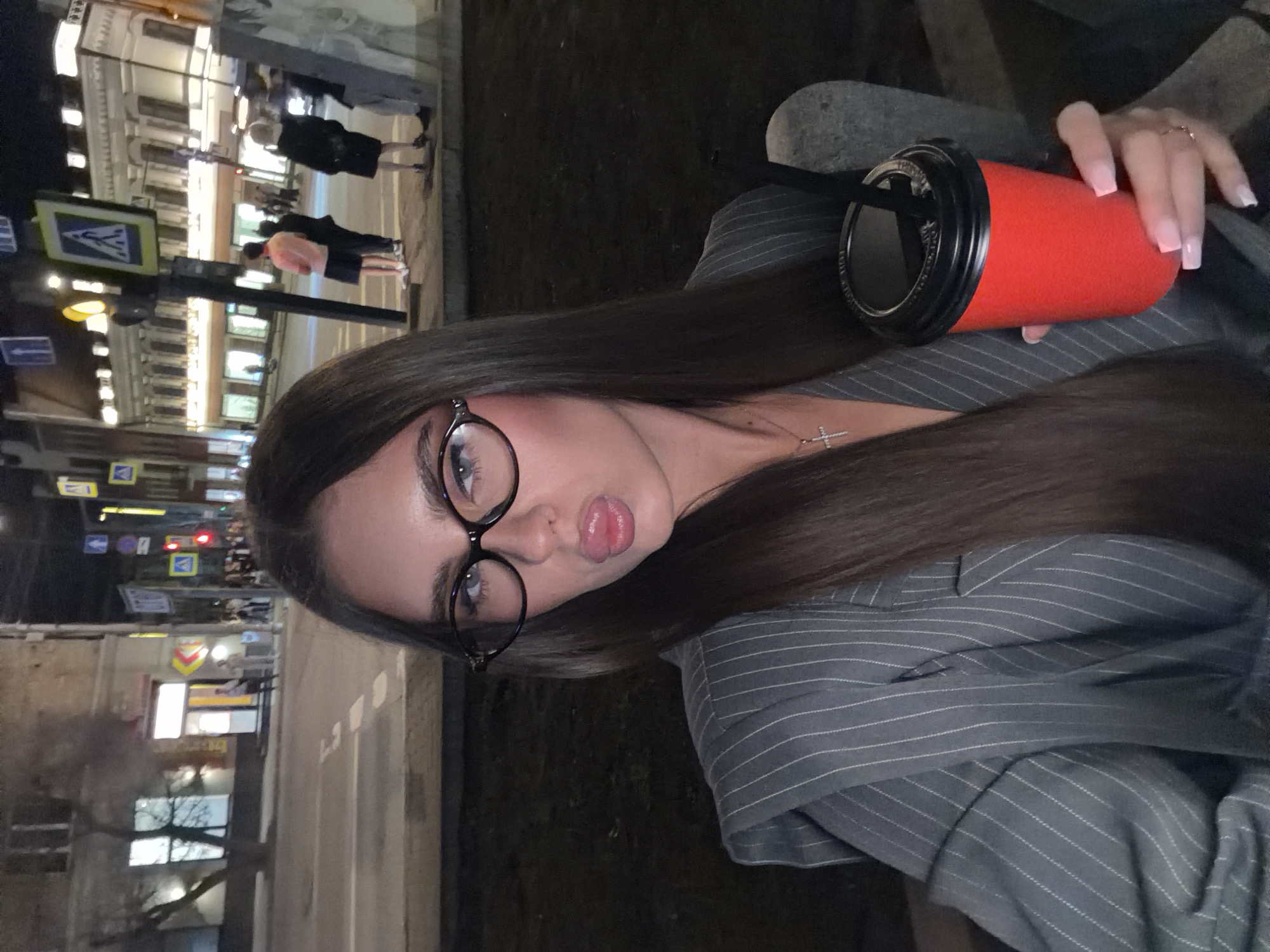 Woman with red cup photographed on Krasnoyarsk streets at night