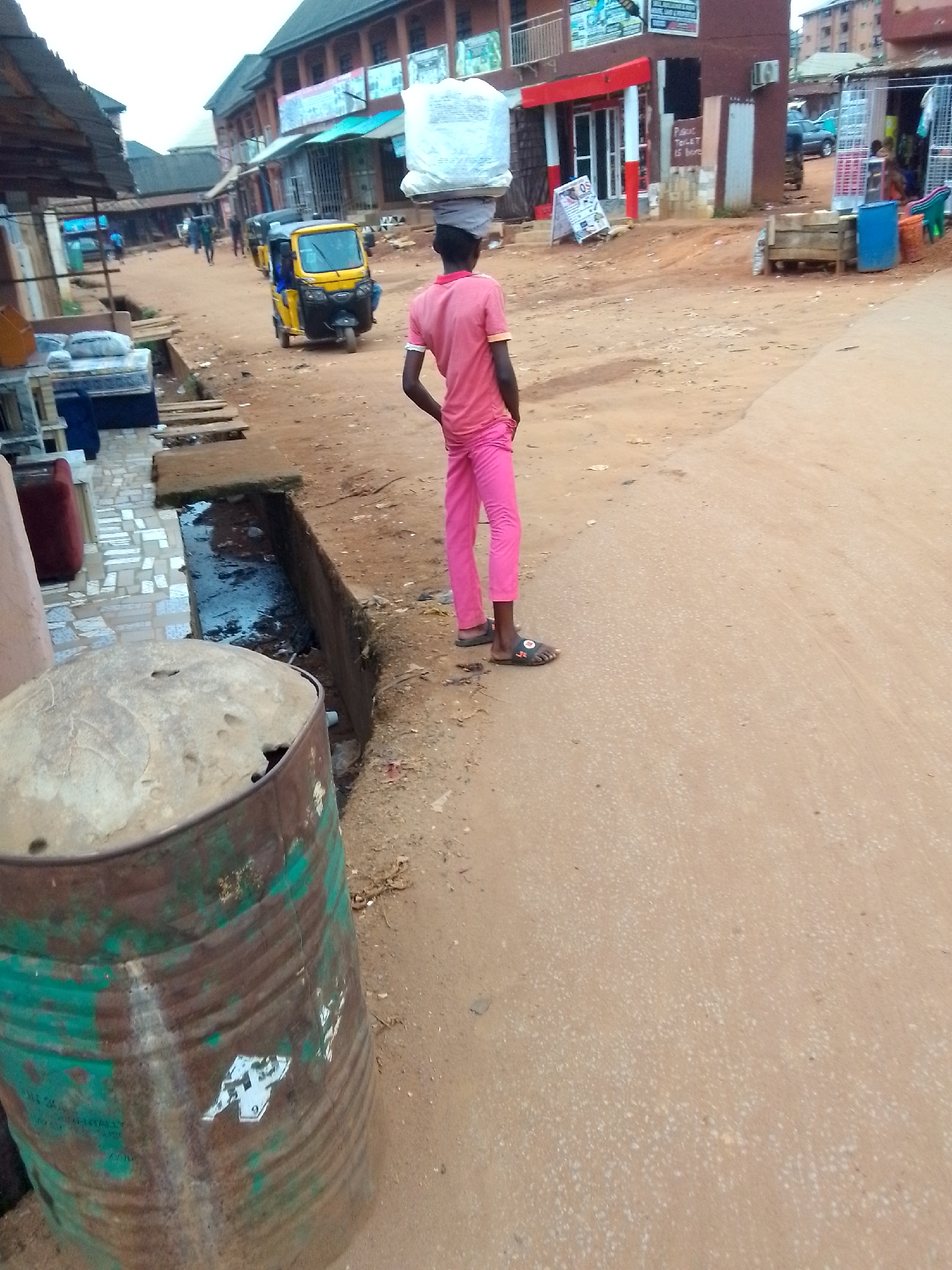 Daily life documented on unpaved streets in Onitsha, Nigeria