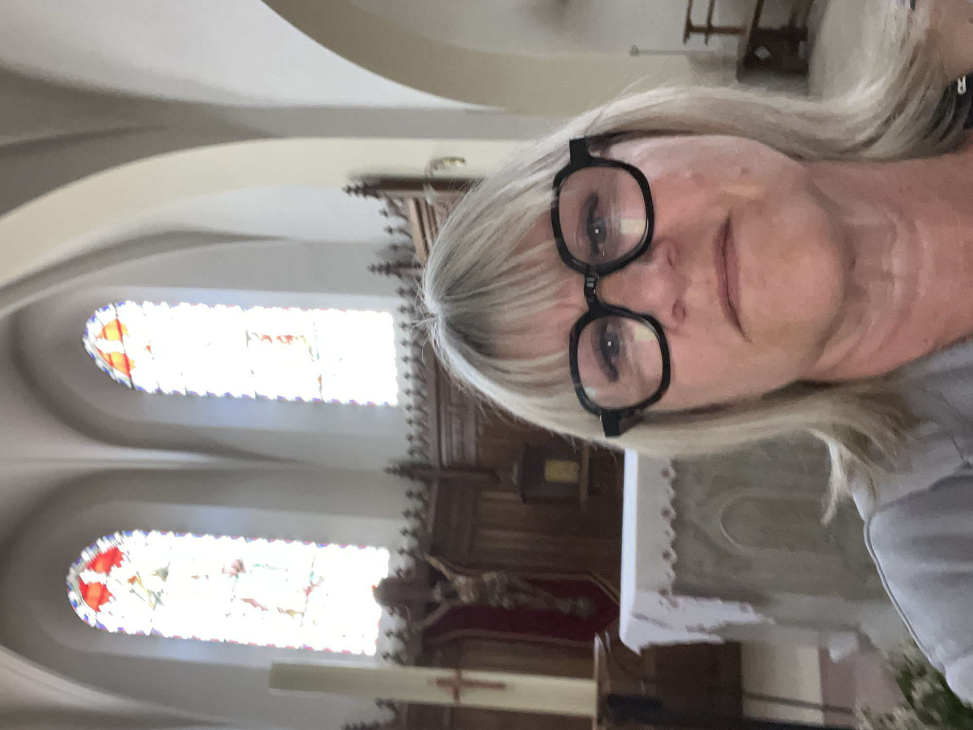 Woman takes selfie inside historic church in Chambœuf