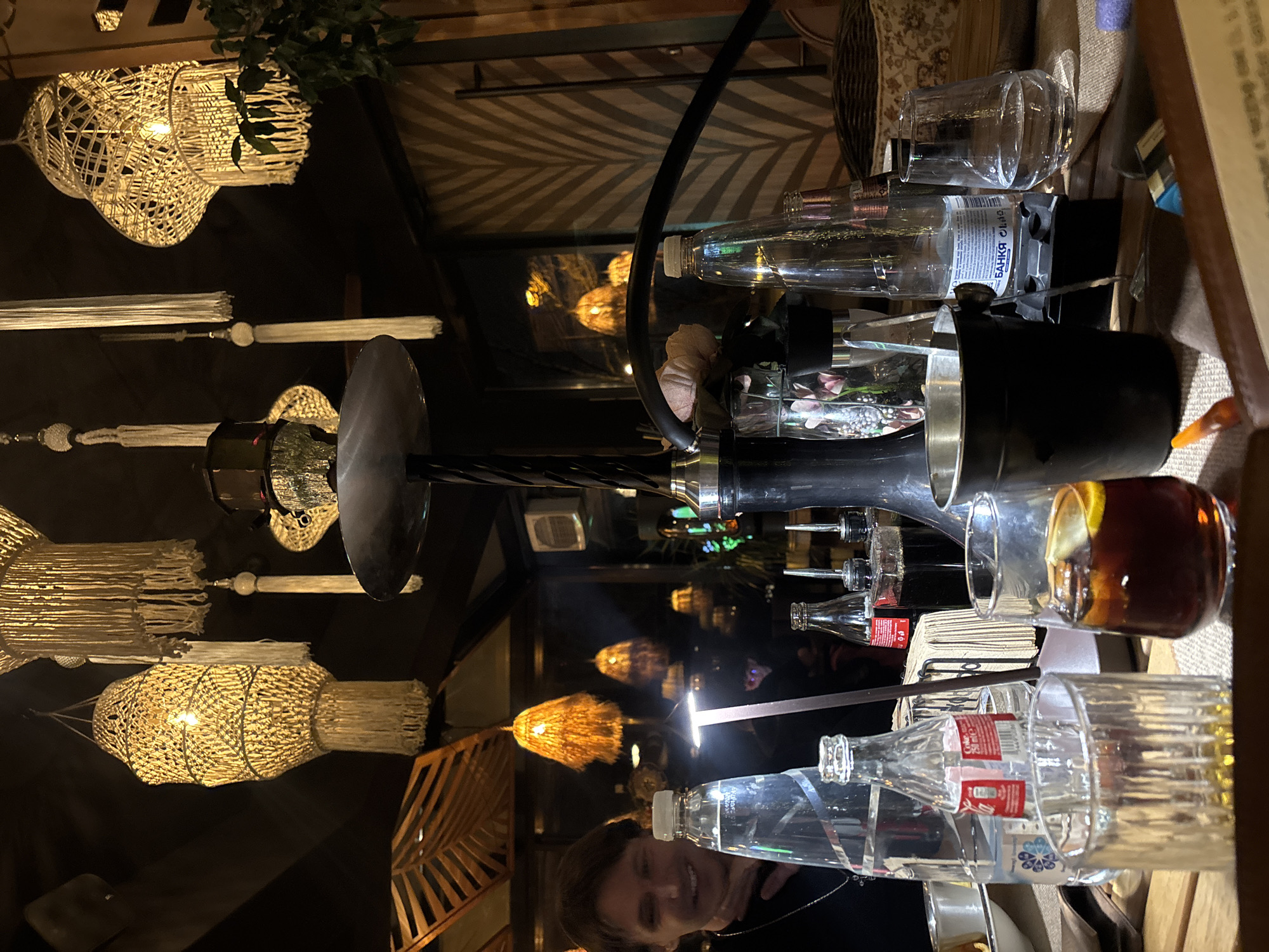 Cluttered table scene captured in dimly lit Sofia establishment