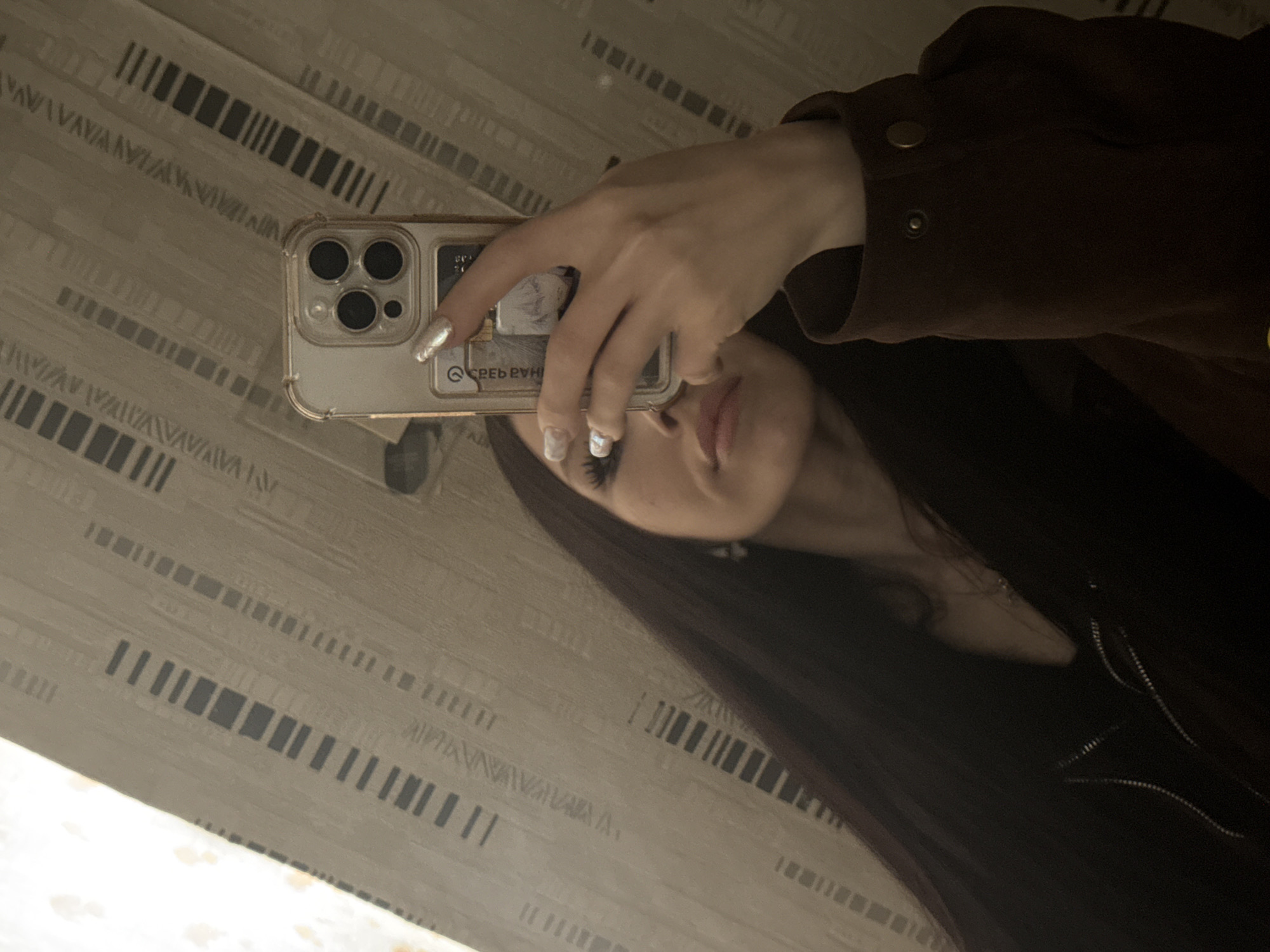 Person takes mirror selfies in Izhevsk indoor setting