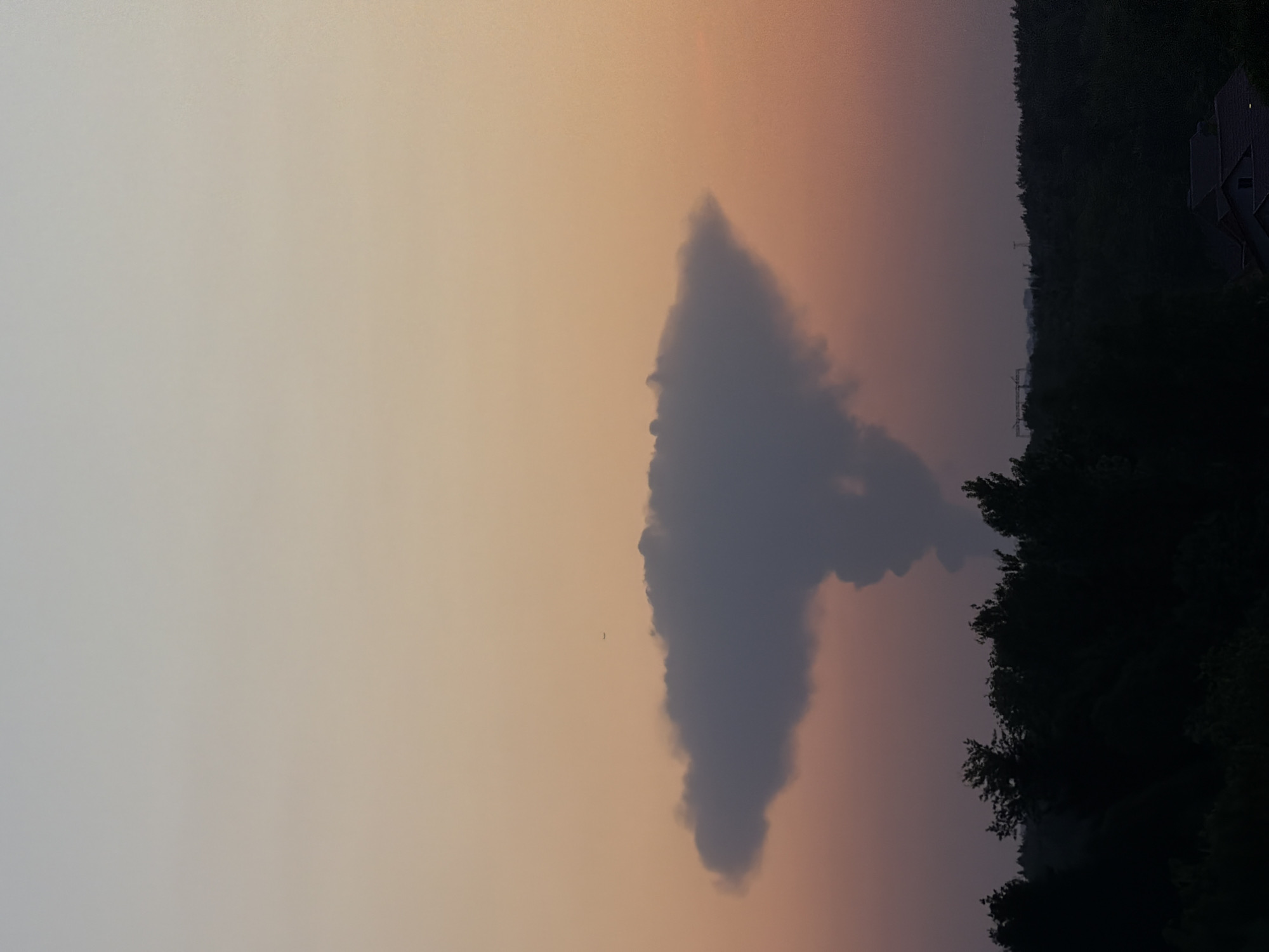 Triangular cloud formation and crescent moon observed during evening twilight