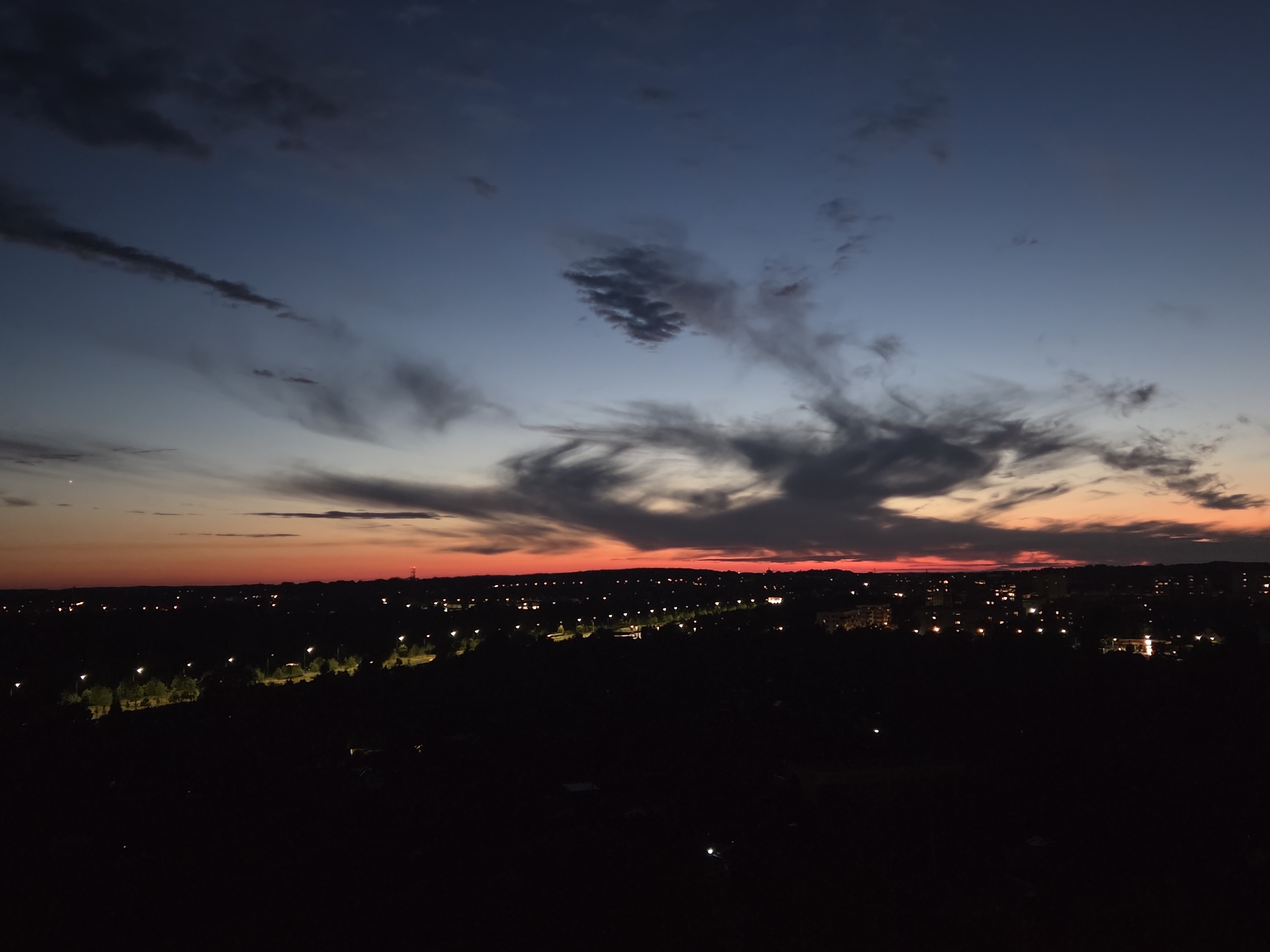 Szczecin skyline at dusk, city lights emerging