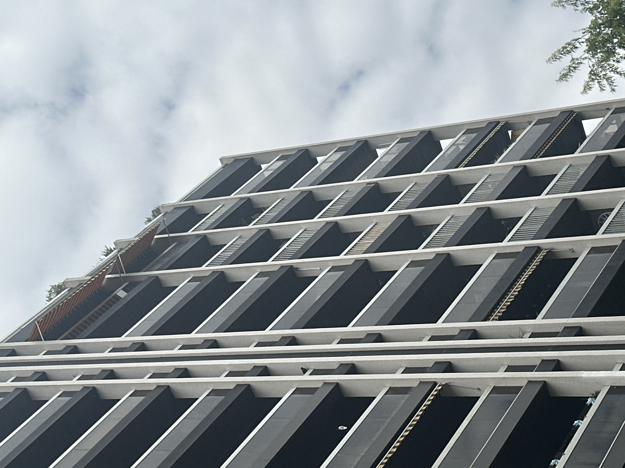Modern Paris residential building with dark balconies and silver railings