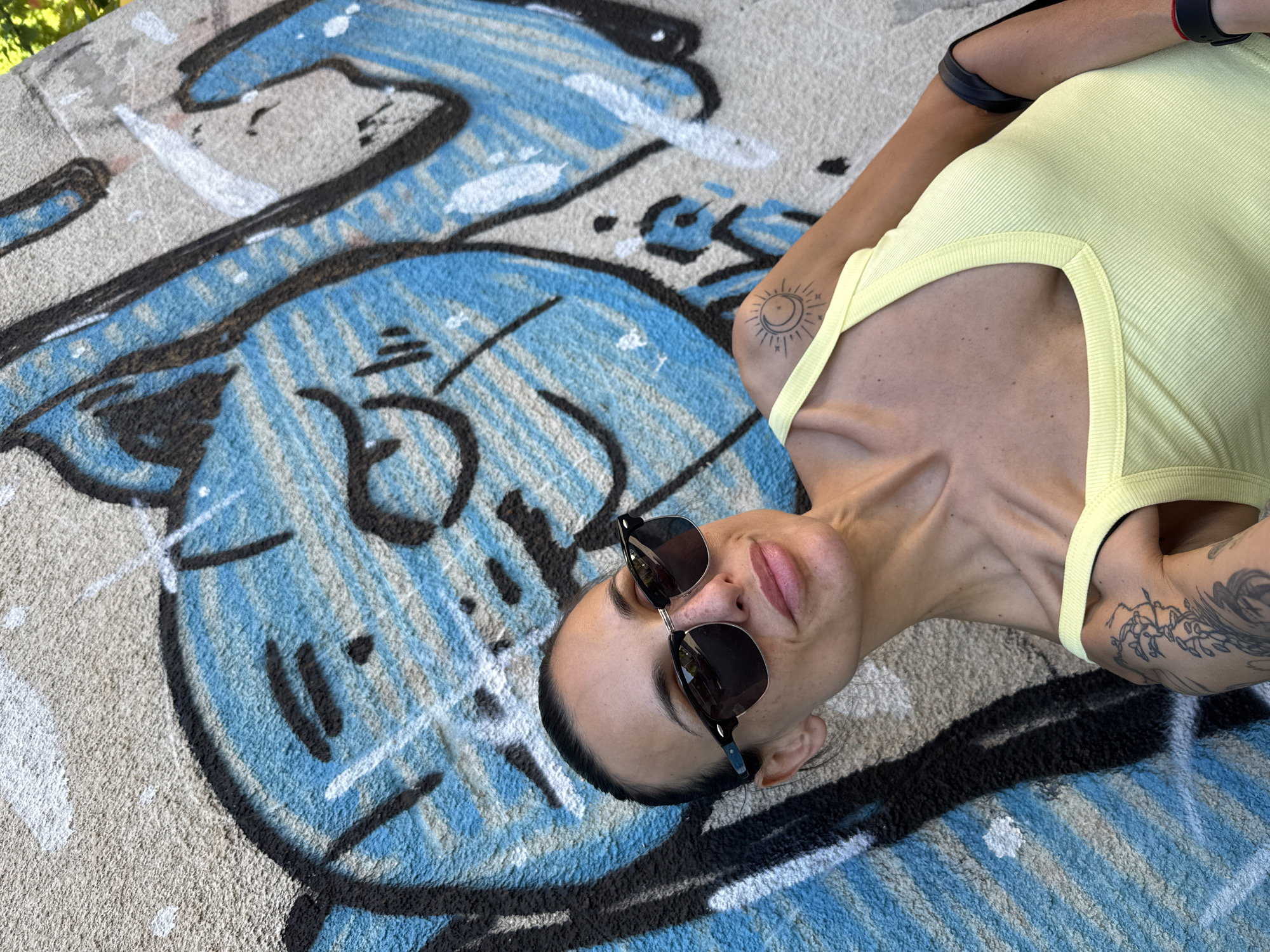 Person photographed lying on graffiti-covered concrete in Pleven, Bulgaria