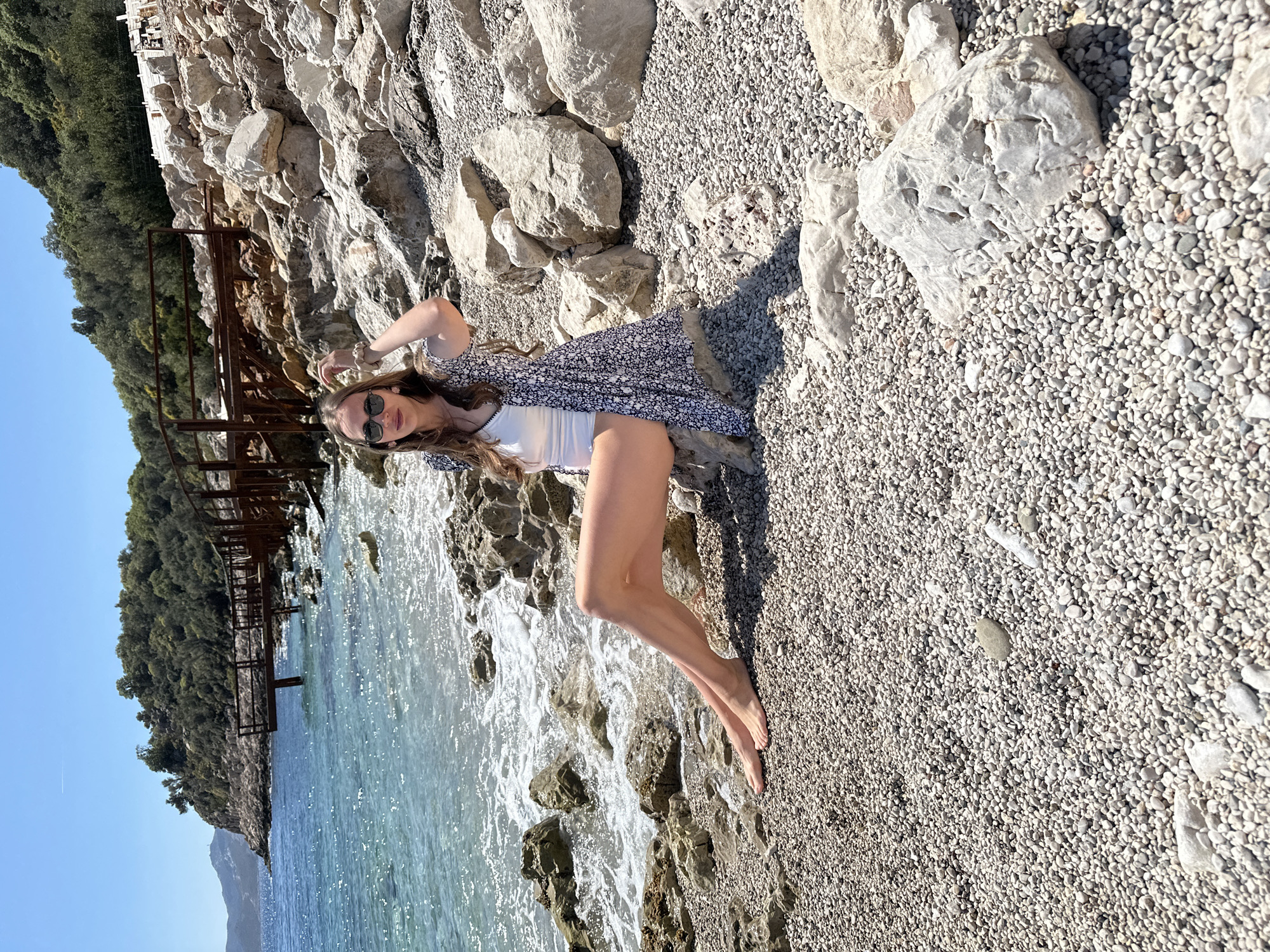 Woman and girl enjoy selfie moment on Turkish pebble beach