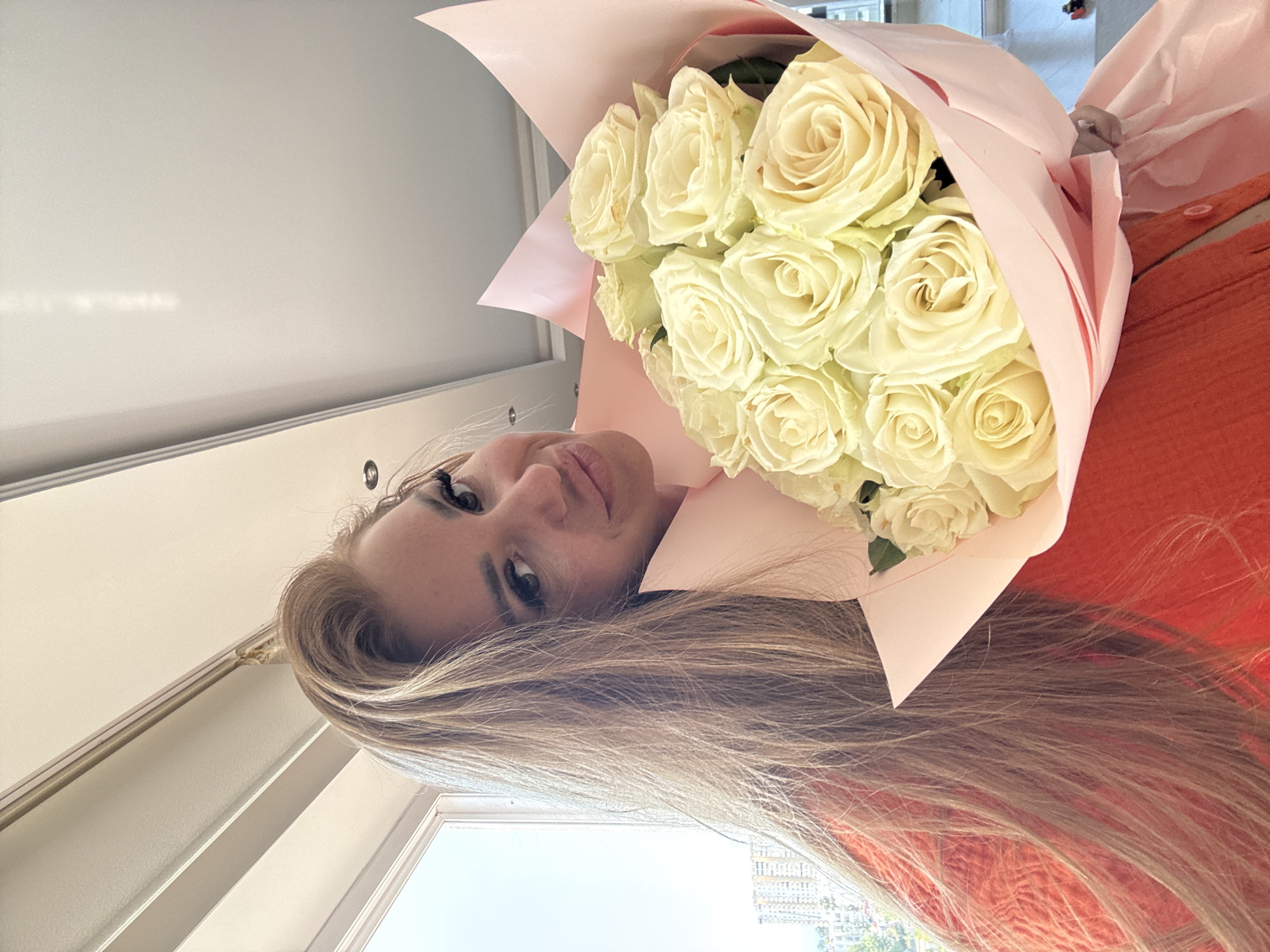 Woman photographed with white rose bouquet in Erdemli