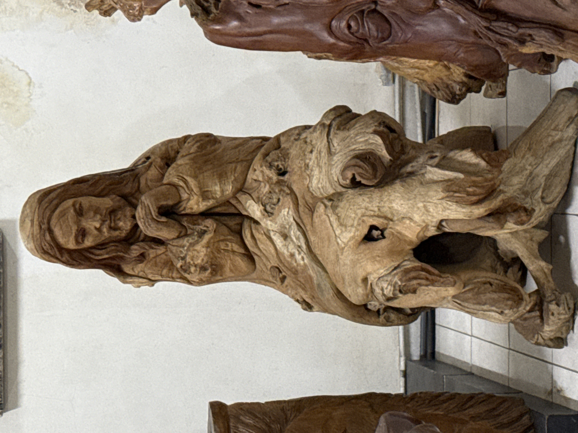 Visitor documents wooden art collection at Denpasar gallery