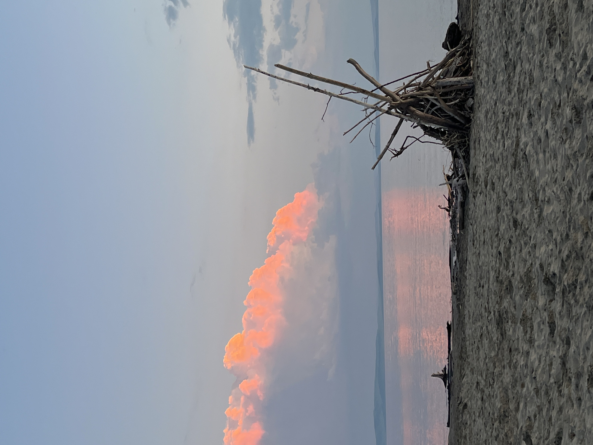 Sunset over calm water at a Siberian lakeshore