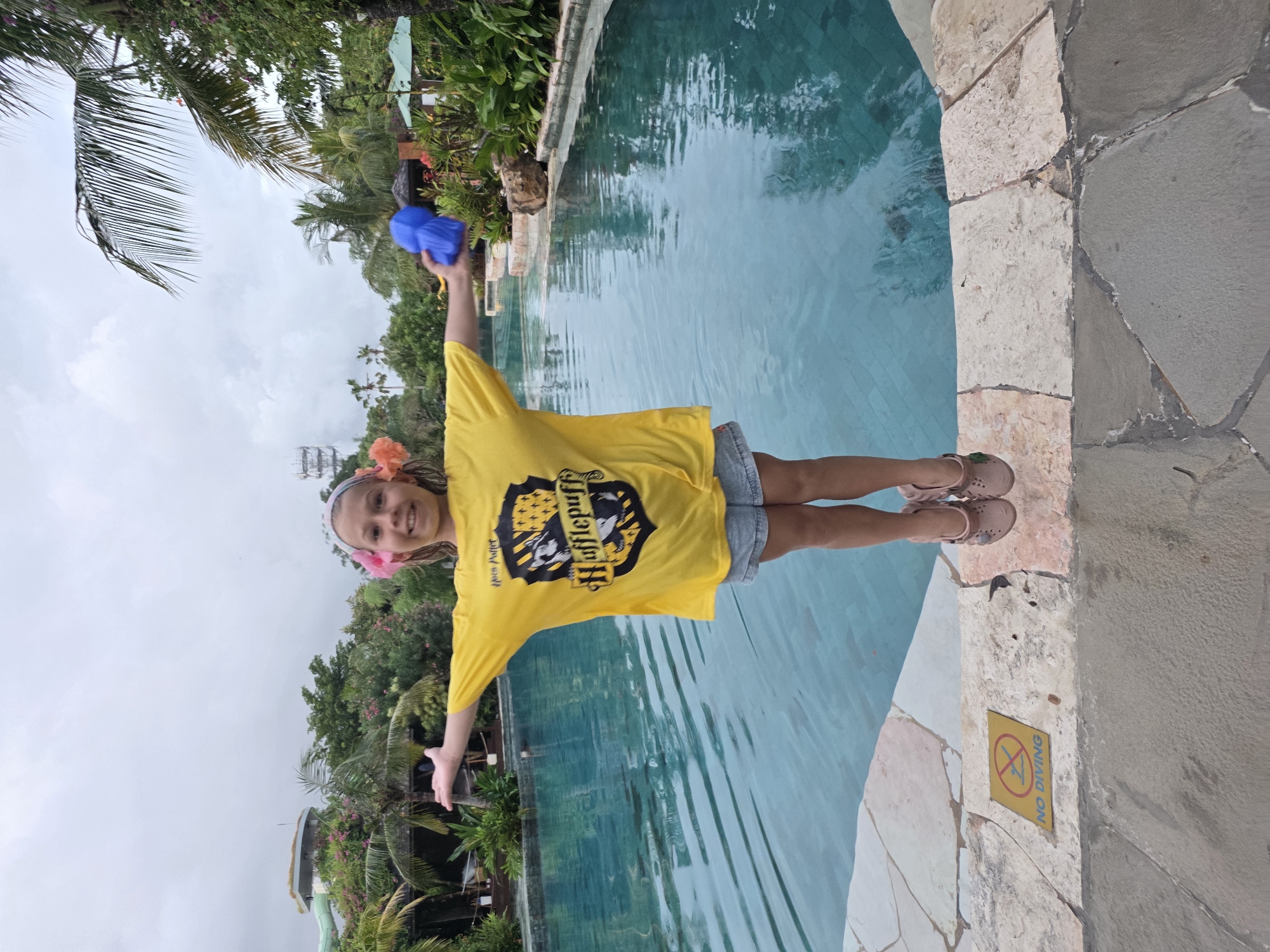 Family enjoys poolside recreation at Kuta resort