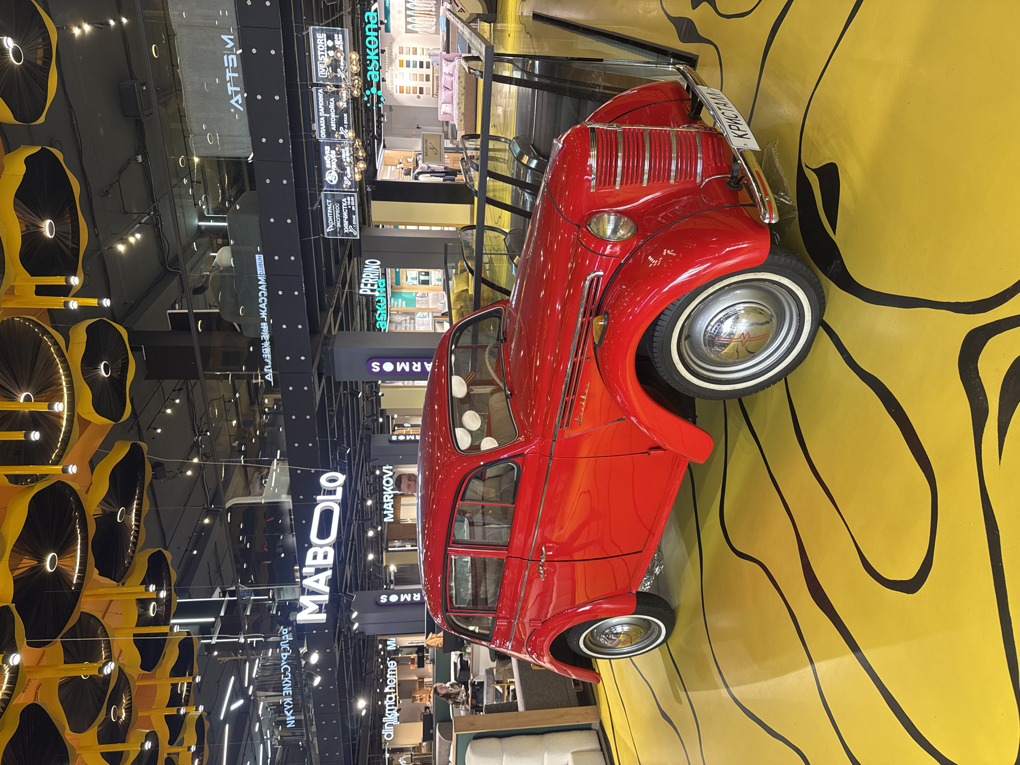 Vintage car and wheel installation documented indoors