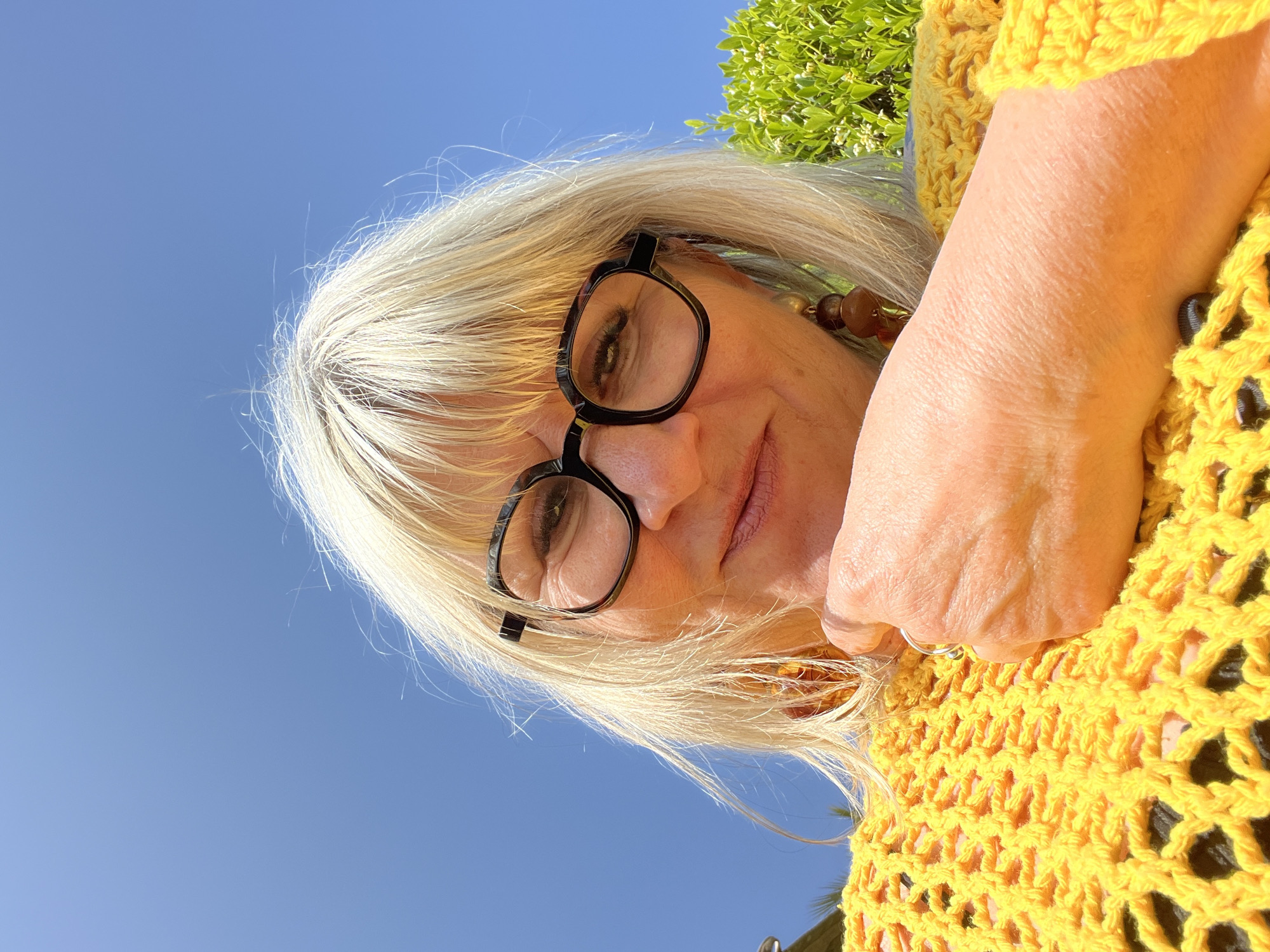 Woman in yellow photographed outdoors in Grimaud, France