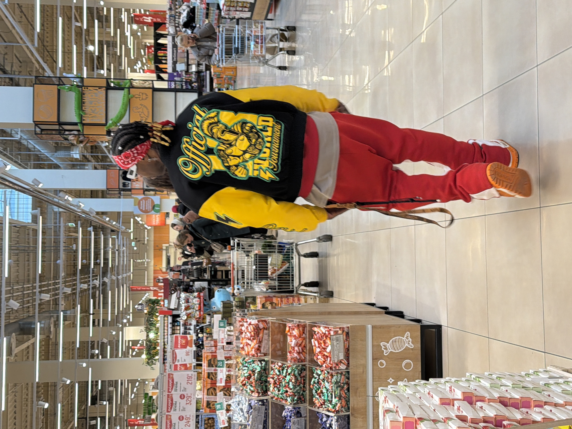 Shopper browses candy aisle at Kommunarka grocery store