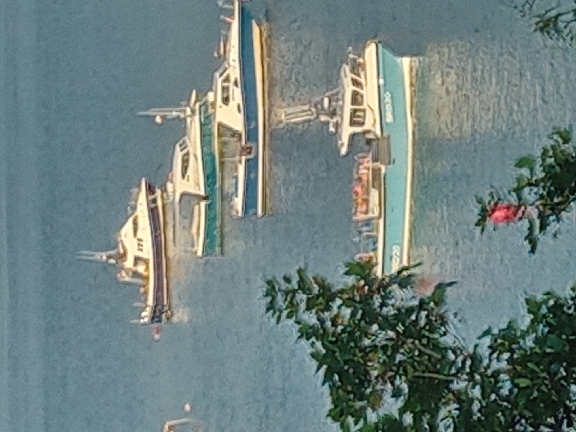 Portree harbour at dusk, boats moored on still water