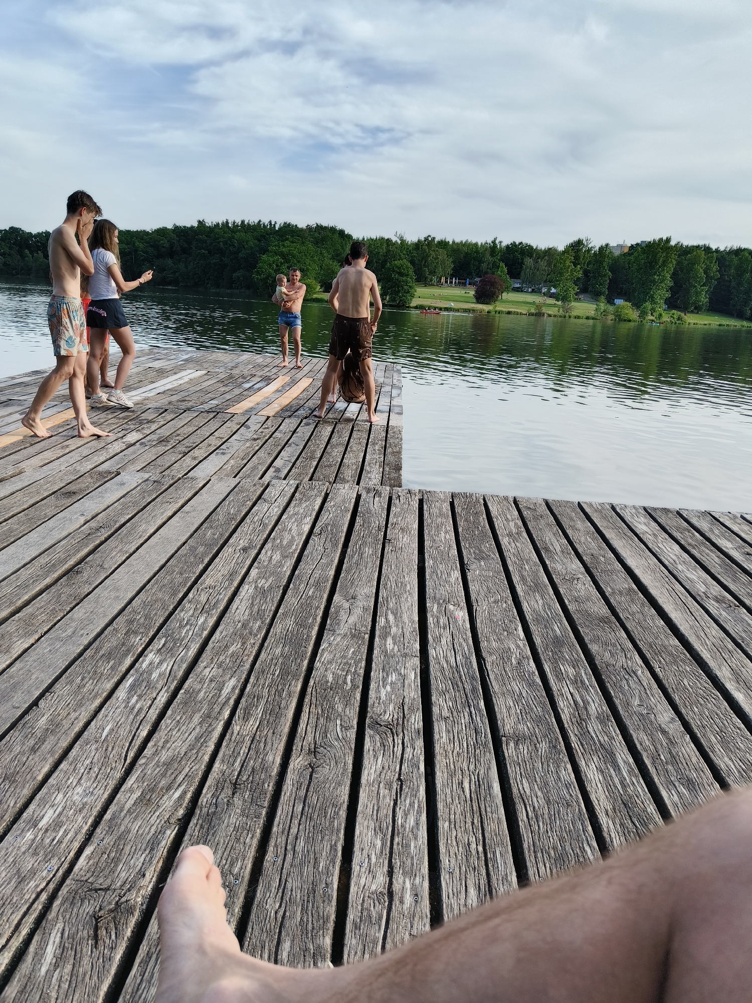 Young people gather at Prague lake pier for swimming