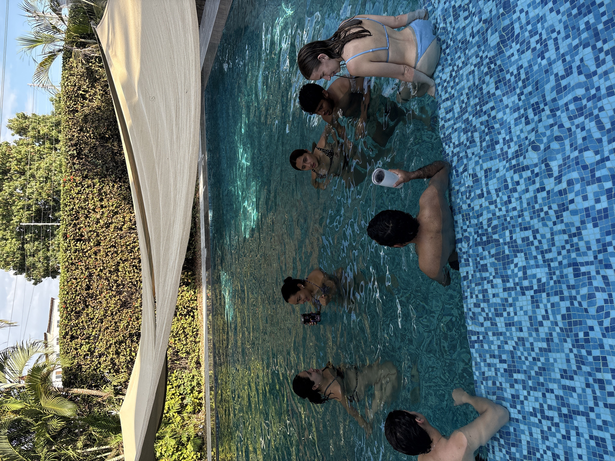 Group of young adults enjoys evening pool gathering in Mexico
