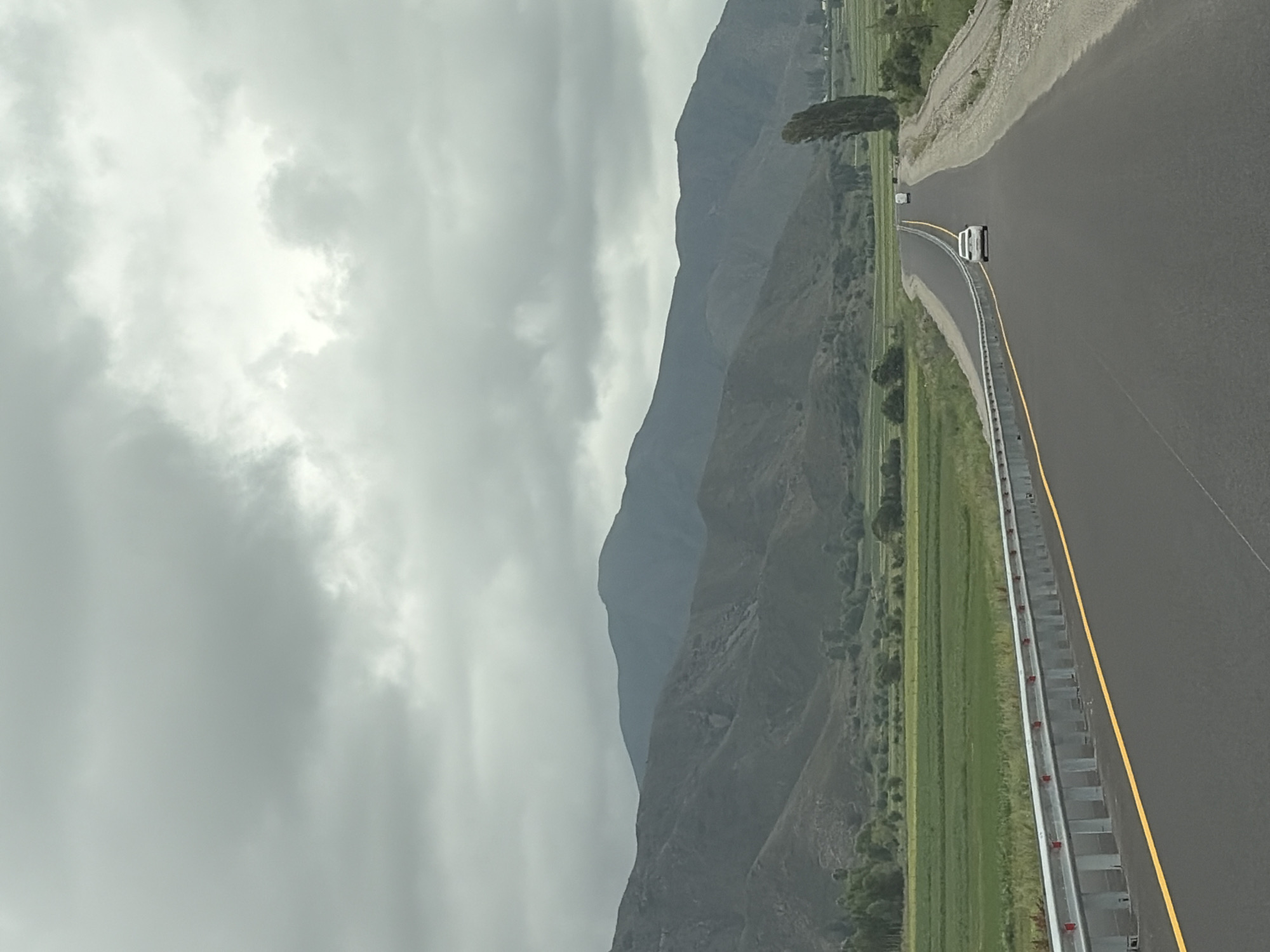 Driving through misty mountain countryside on an overcast morning