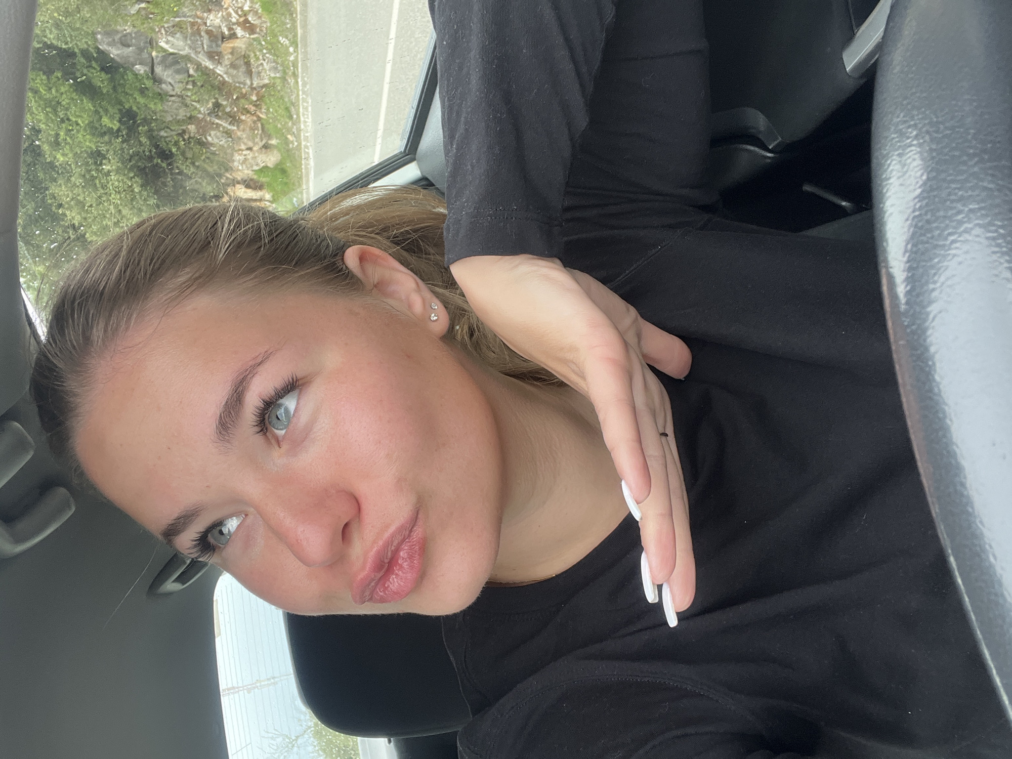 Woman applies cosmetics in car in Montenegro