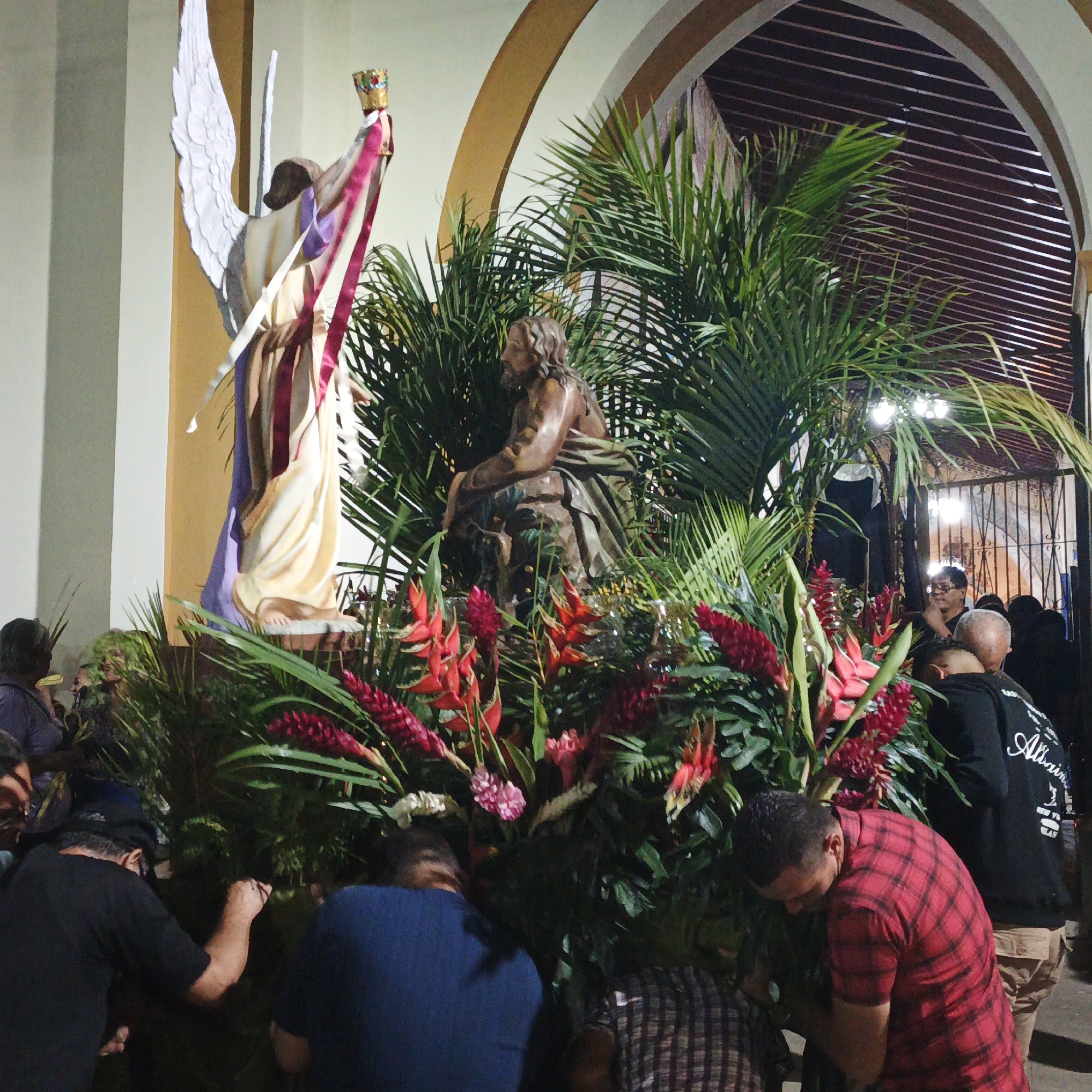 Religious procession with statues and marching band in Tinaquillo