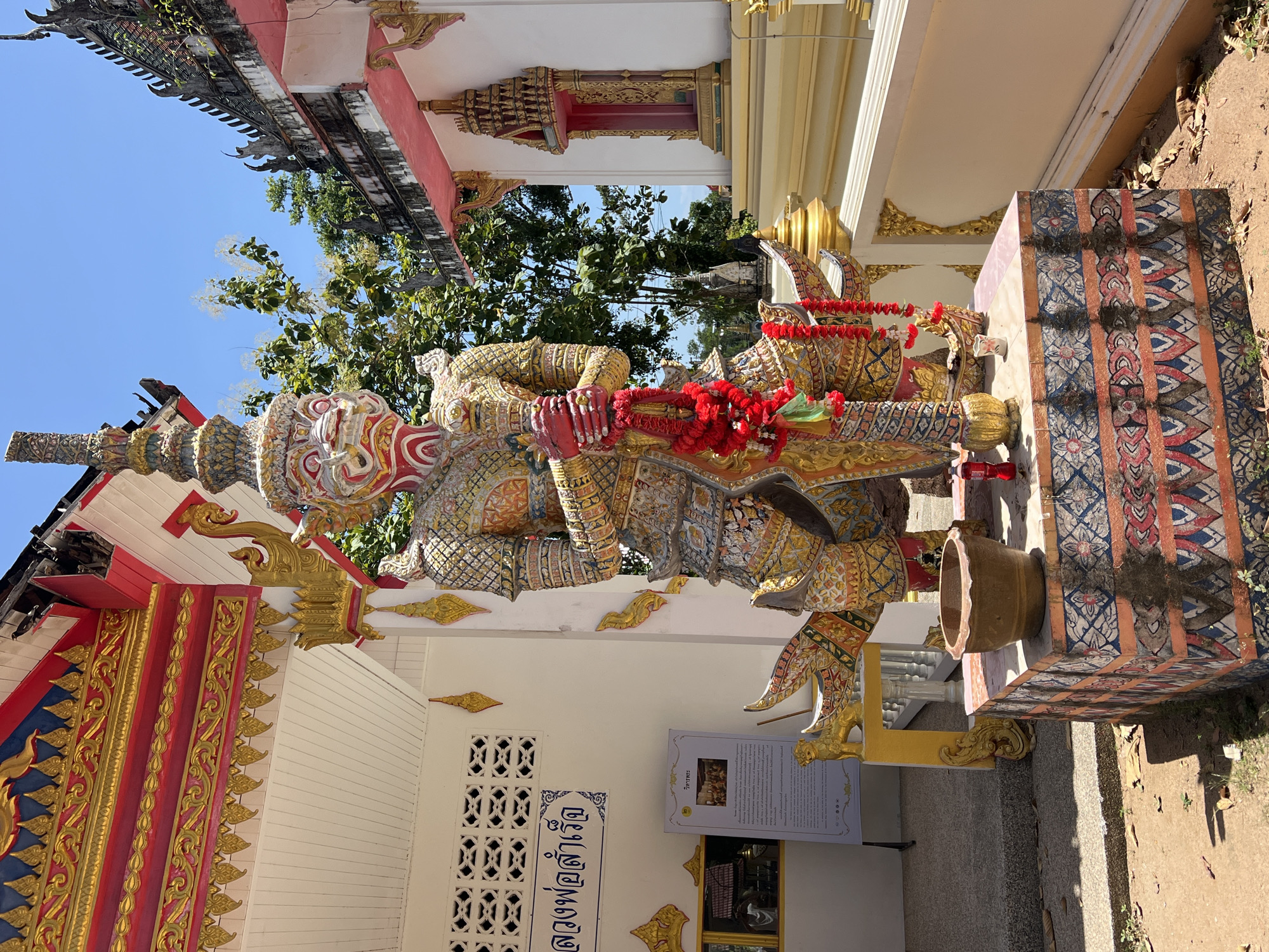 Ornate guardian statues and Ganesh outside a Ko Samui temple
