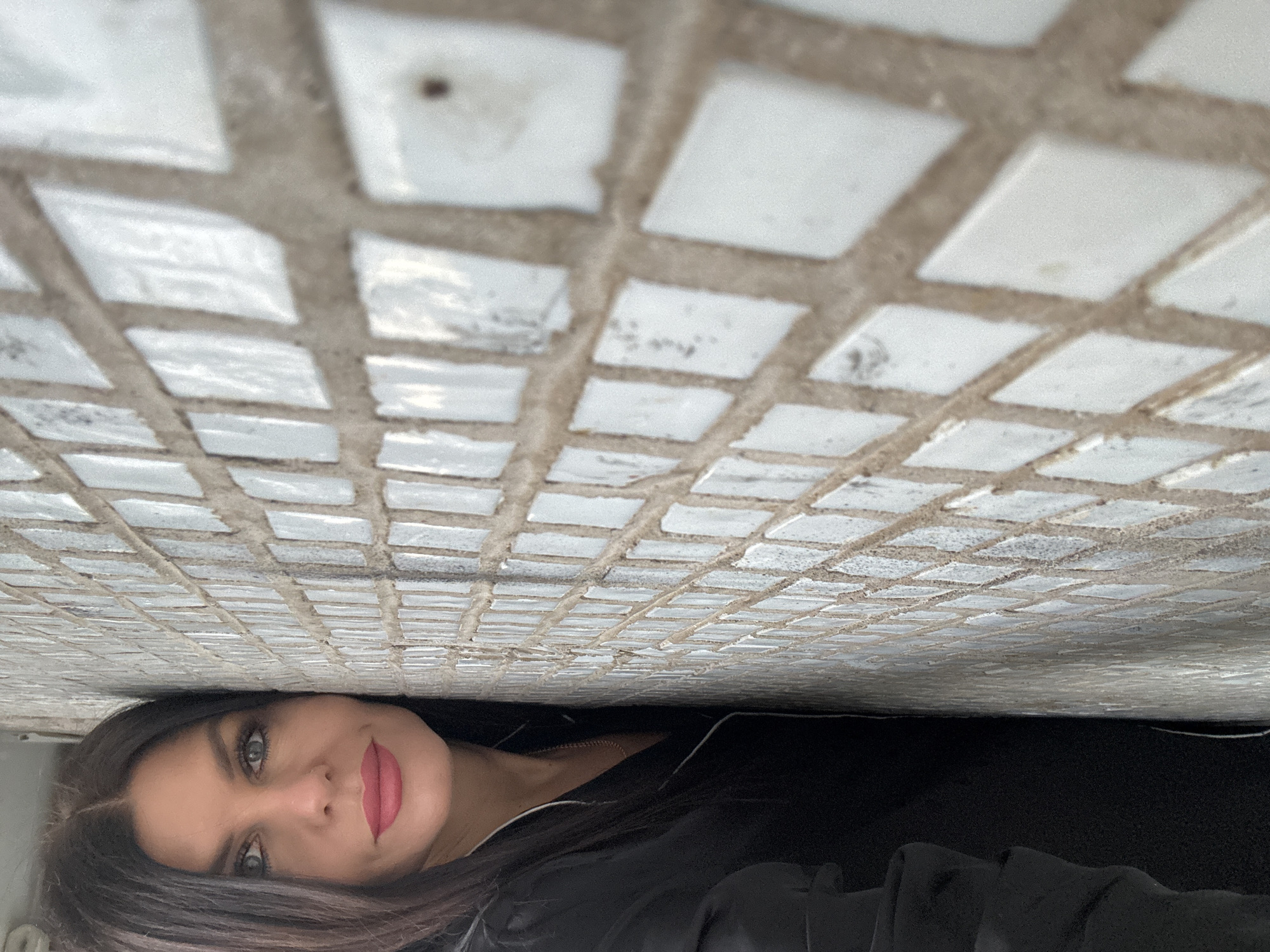 Woman emerges from under tiled surface in Chaikovsky