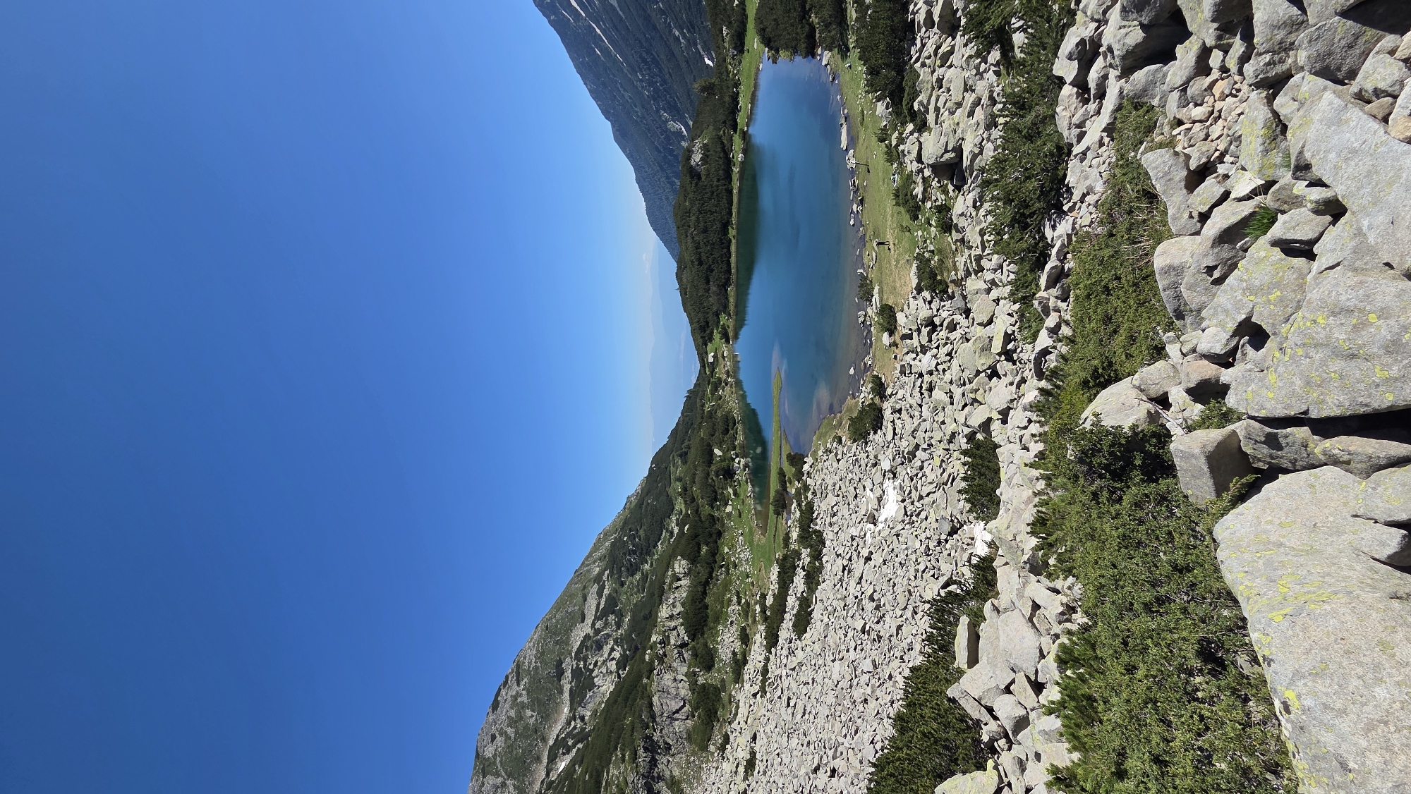 Rocky alpine lake in the Bulgarian mountains, clear summer day