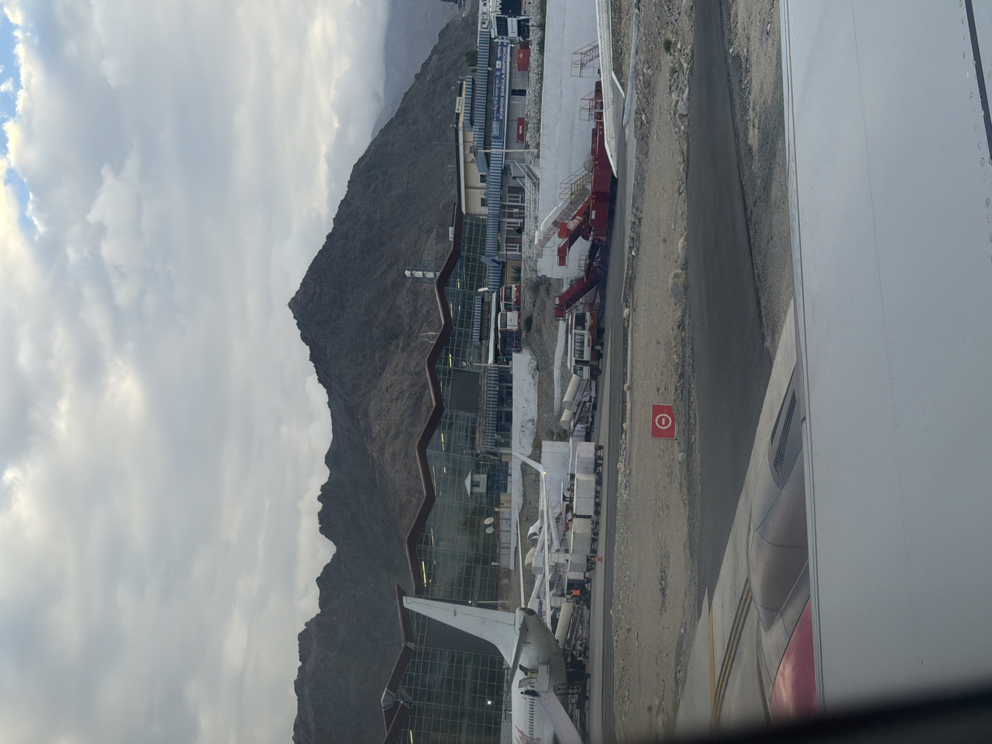 SpiceJet on the tarmac at Leh Airport, Himalayas behind