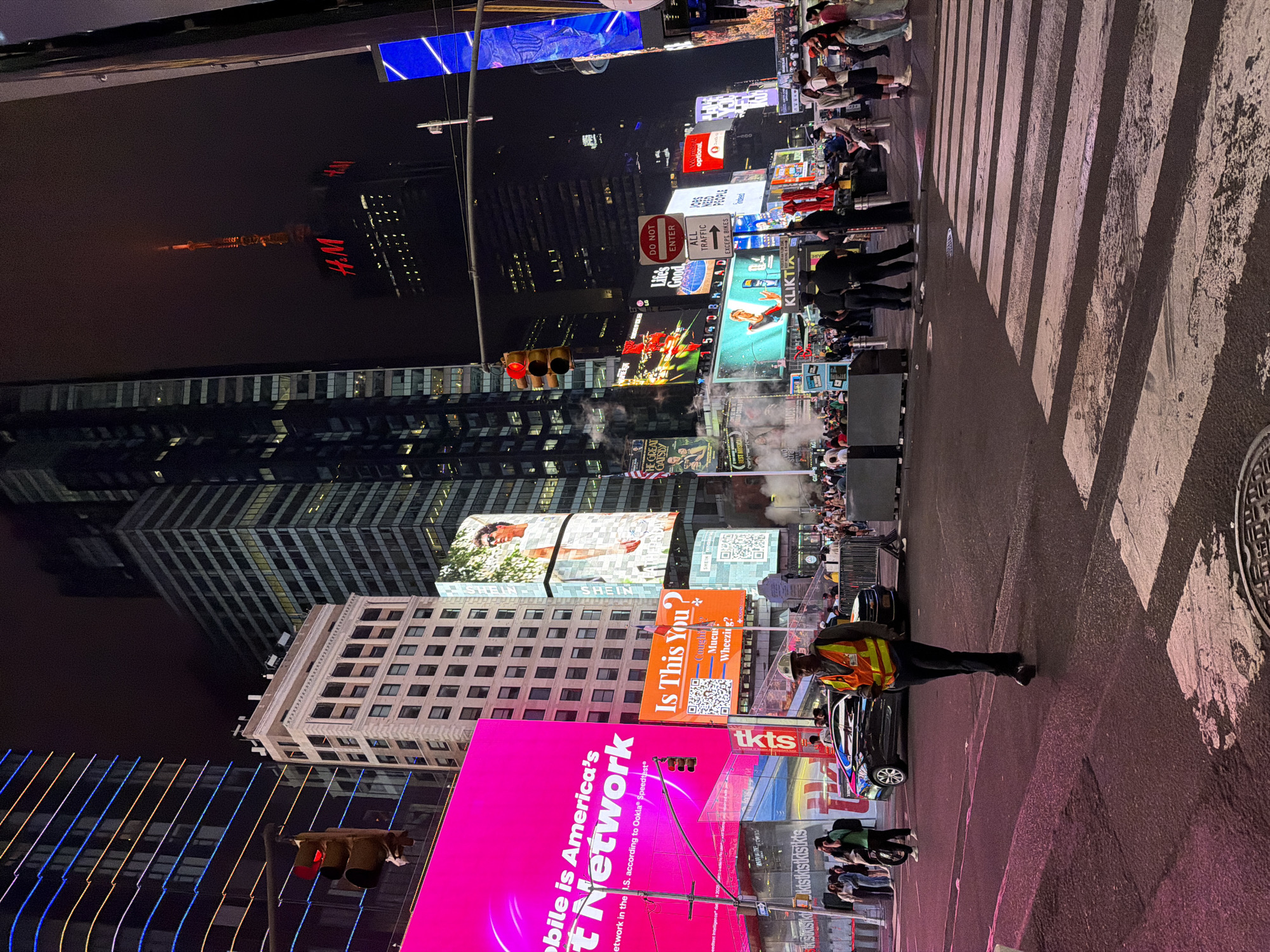 Times Square at 4am, billboards blazing through the fog